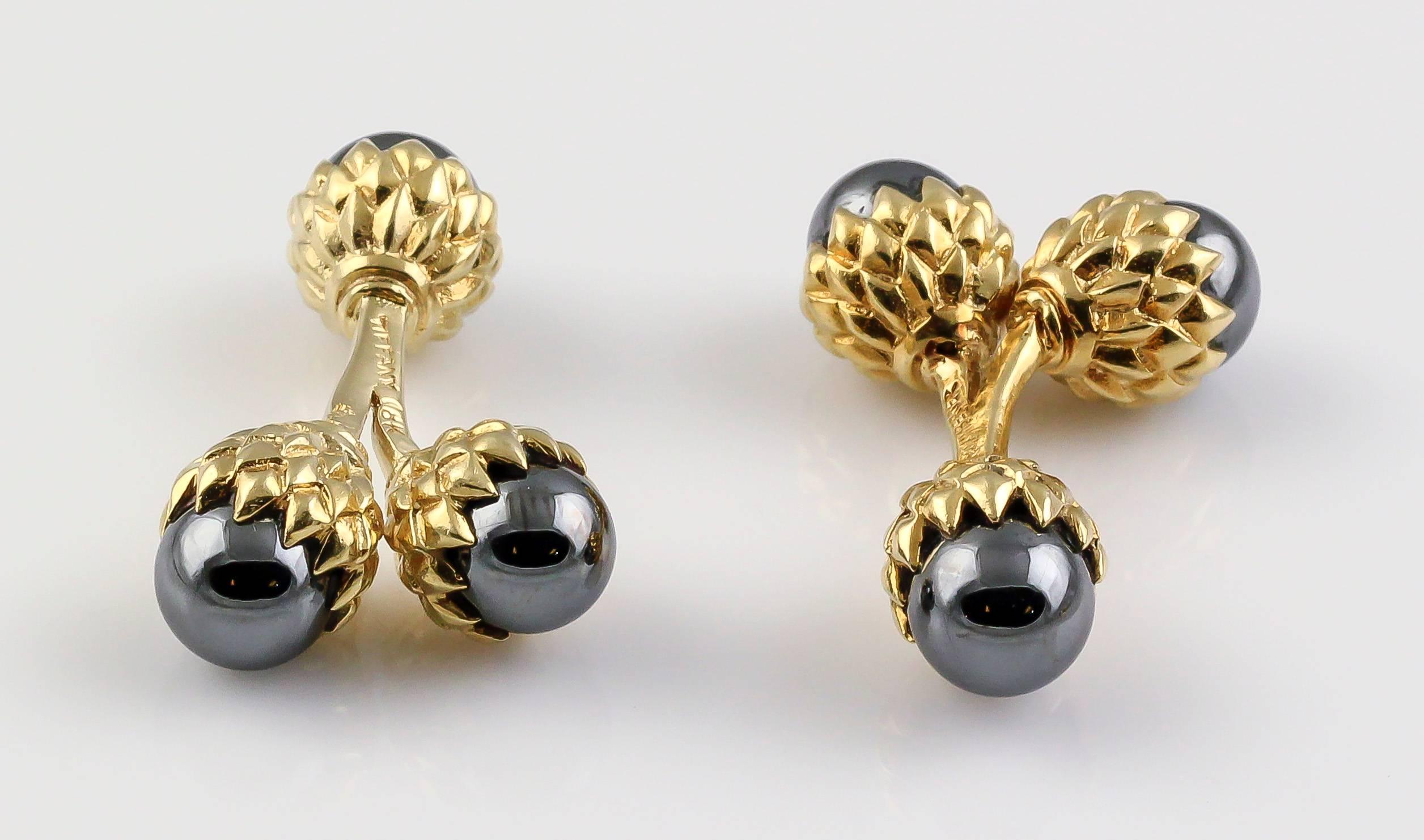 Rare and unusual hematite and 18K yellow gold double acorn cufflinks by Tiffany & Co. Schlumberger. These are much harder to find than the single acorn cufflinks, which retail for $2400. Beautifully made and strikingly handsome.

Hallmarks: