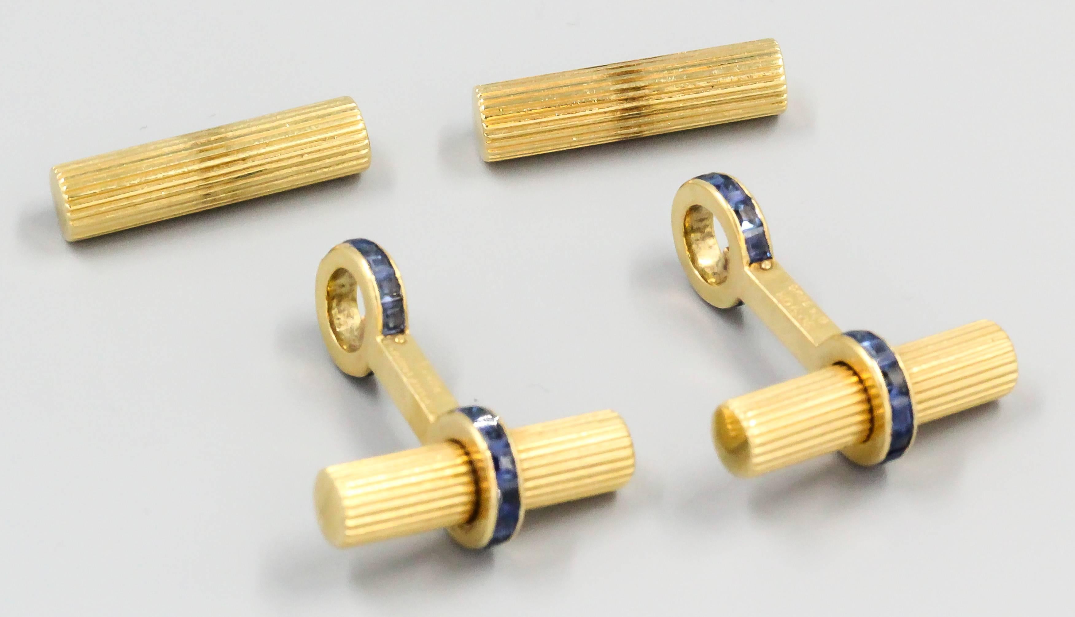 Very handsome sapphire and 18K yellow gold bar cufflinks by Van Cleef & Arpels, circa 1960s-70s. They resemble ribbed gold bars, with rich blue sapphires. One end of the bars twists off for ease of installation. 

Hallmarks: Van Cleef & Arpels,