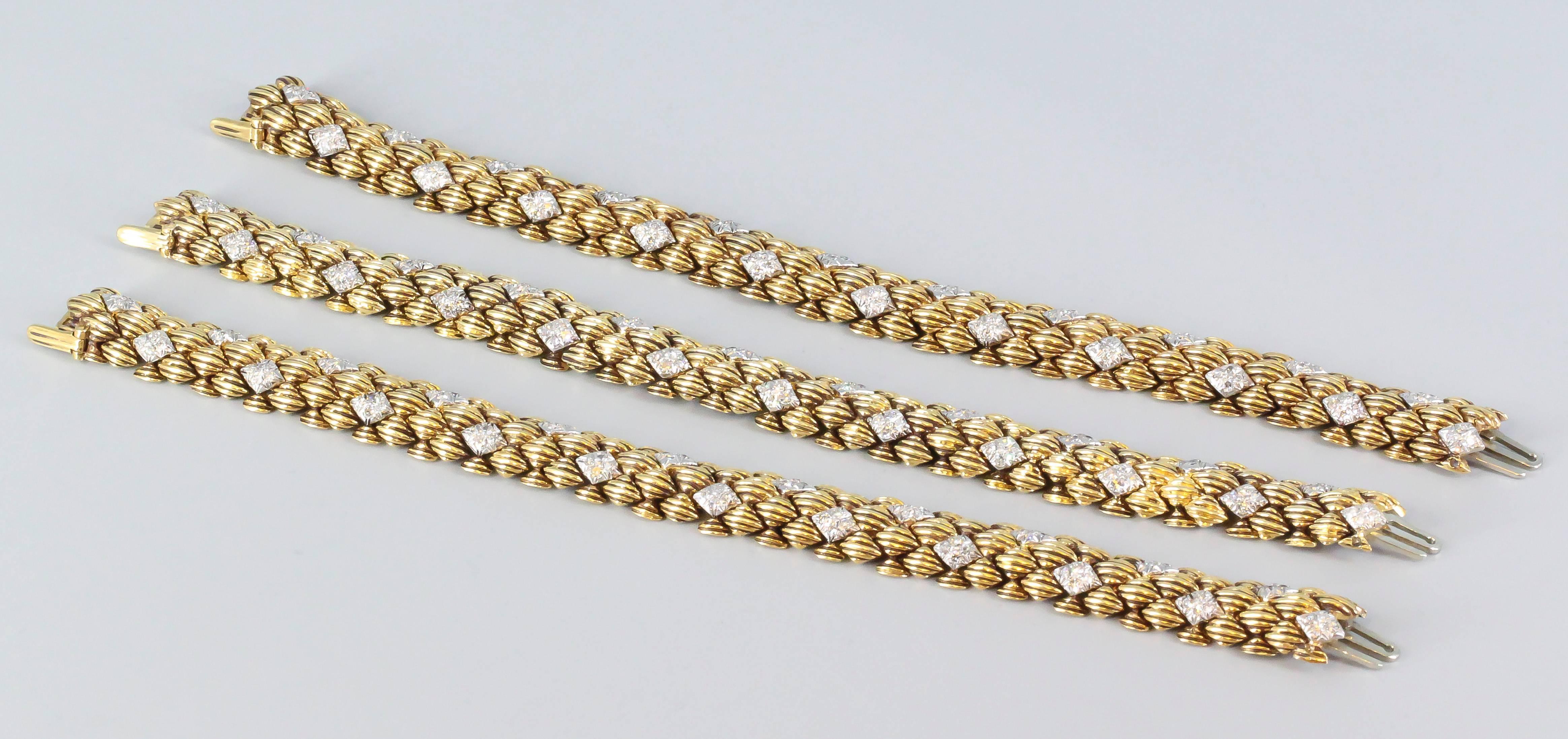 Very fine and bold trio of diamond and 18K yellow gold link bracelets by David Webb. They feature high grade round brilliant cut diamonds, with ribbed links throughout. Beautifully made and a very chic look. 

Hallmarks: Webb, 18k.