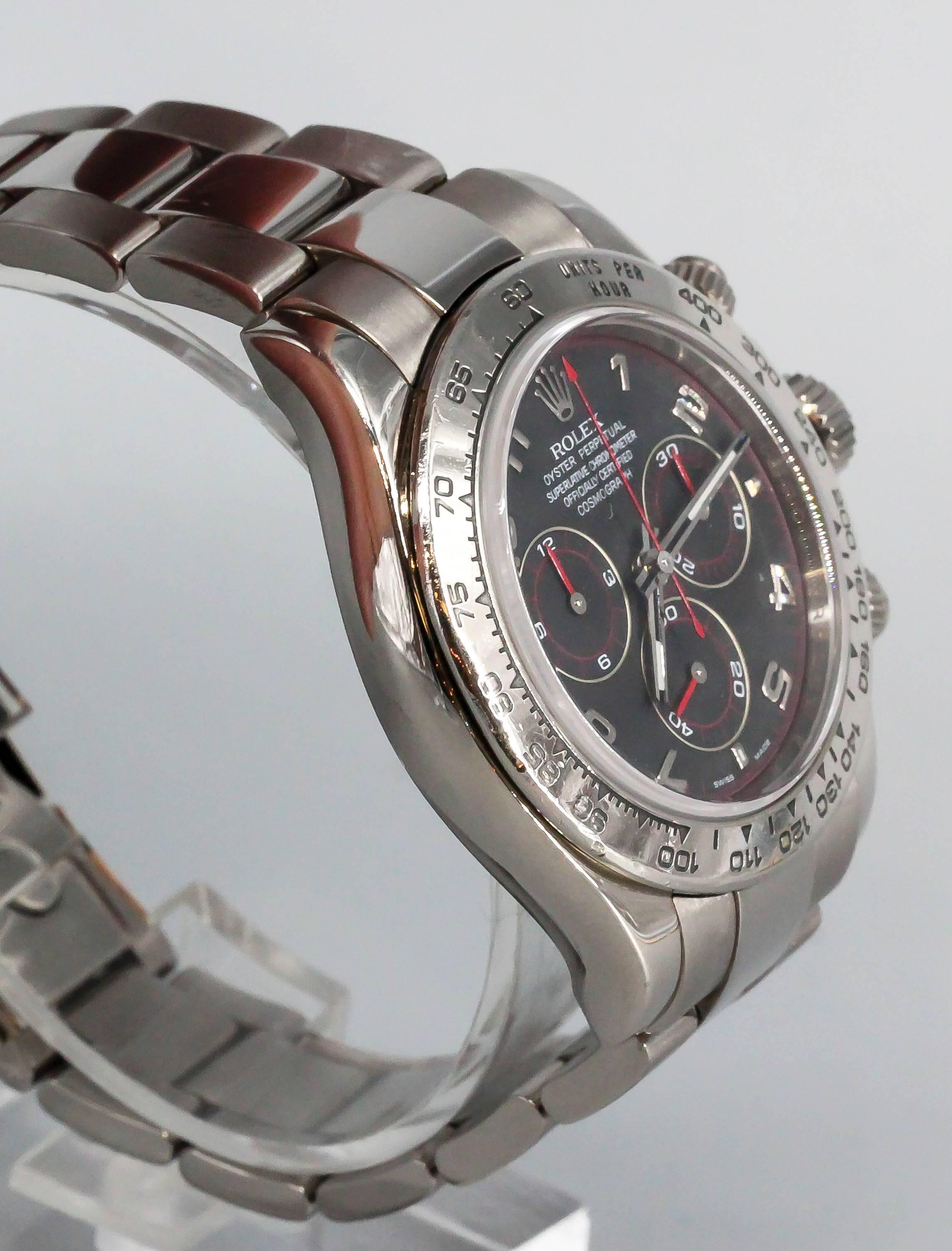 Handsome 18K white gold Rolex Cosmograph "Daytona" wrist watch. This is the "Z" series with the inscribed inner bezel. Automatic movement. Beautiful black dial with red accents. Comes with Rolex 18K white gold link bracelet and