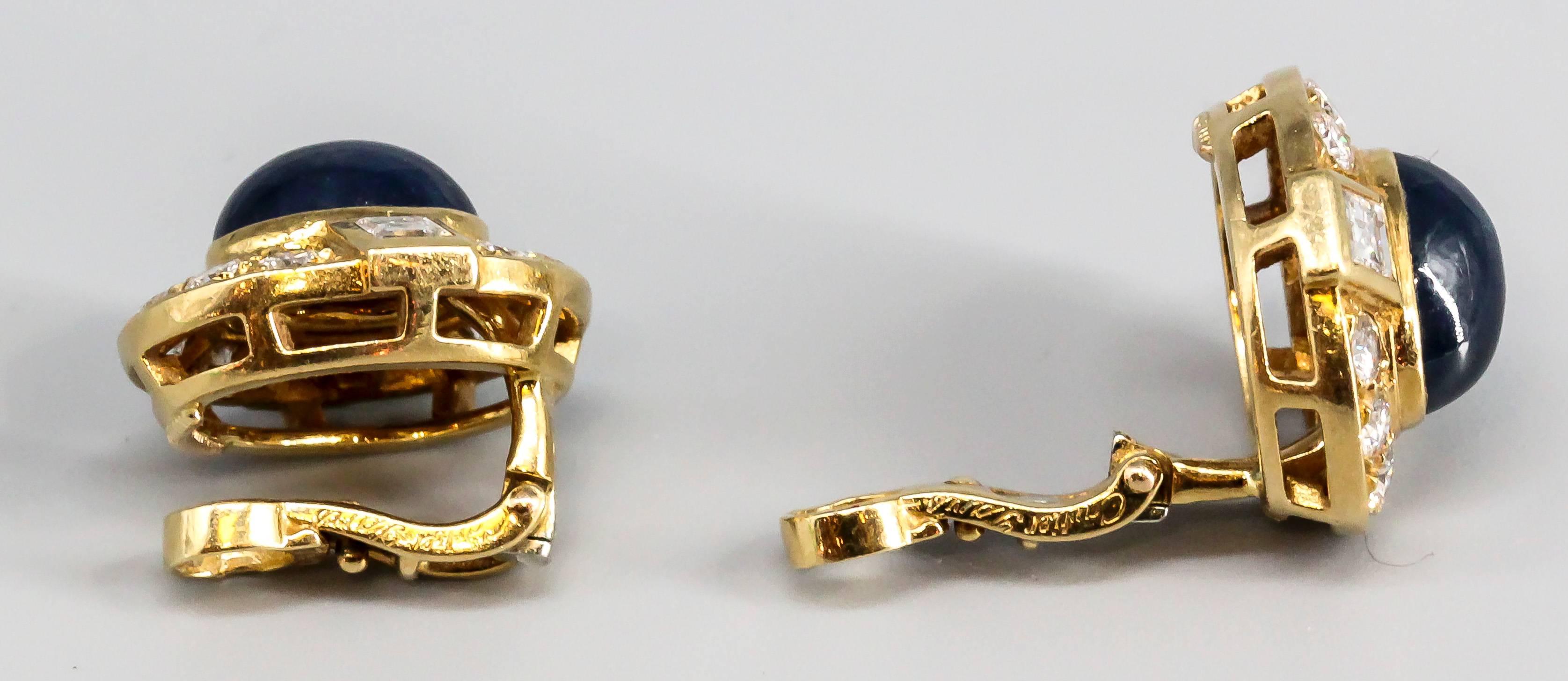 Elegant cabochon sapphire, diamond and 18K yellow gold earrings by Cartier, made in Paris. They feature rich blue oval cabochon sapphires in the center, surrounded by very high grade round and square cut diamonds. Beautifully made.

Hallmarks: