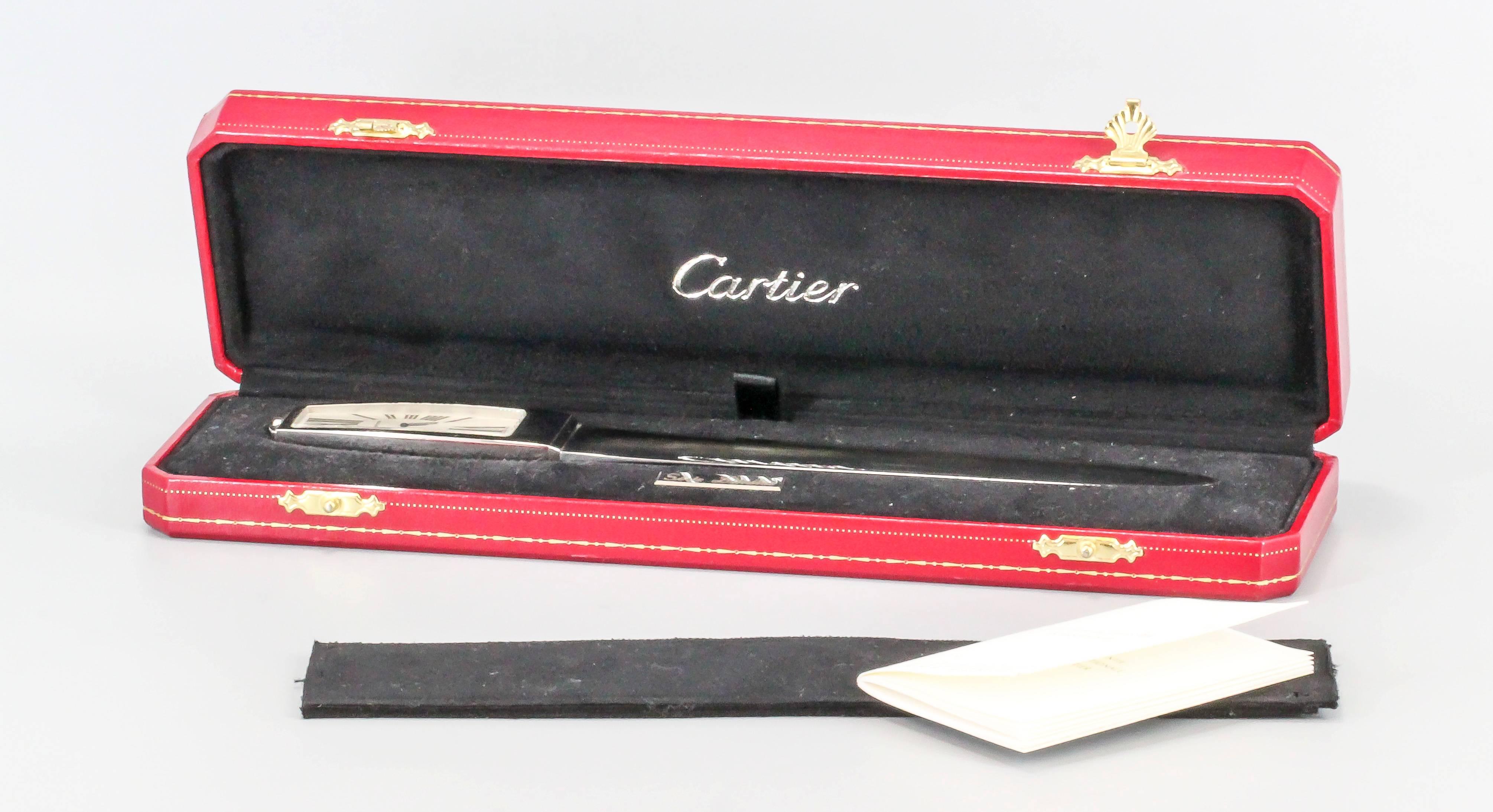 Handsome limited edition (#1396 of 2000 made) clock/letter opener by Cartier. It features a large clock at the end of it, with a quartz movement and roman numerals. Comes with original Cartier box and open papers. Beautifully made and would make a