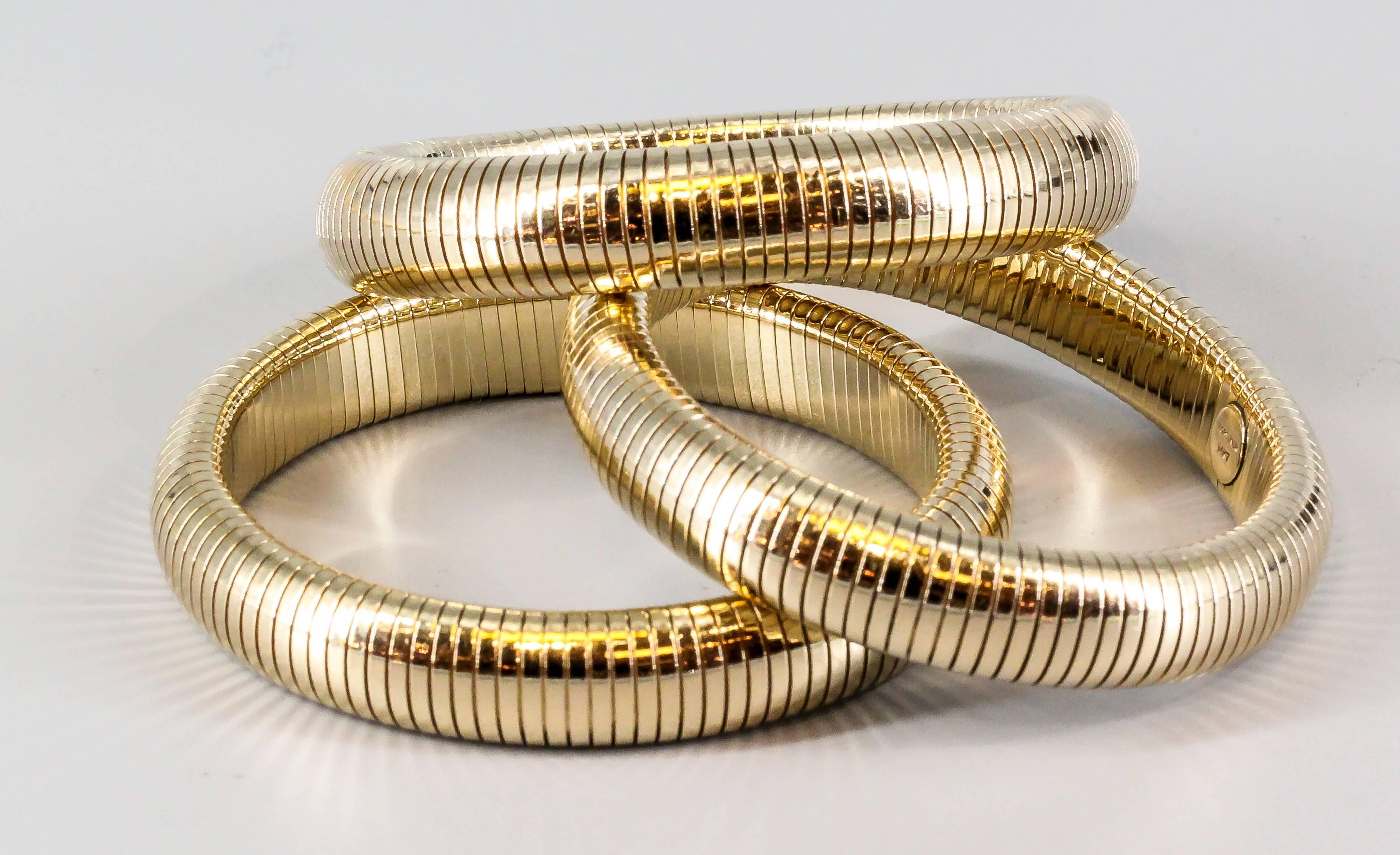 Chic and interesting 14K yellow gold flexible bangle bracelets by Forstner. They feature a flexible spring design reminiscent of various Bulgari pieces from the Tubogas collection, these being form the 1940s. All three bracelets are approx. the same
