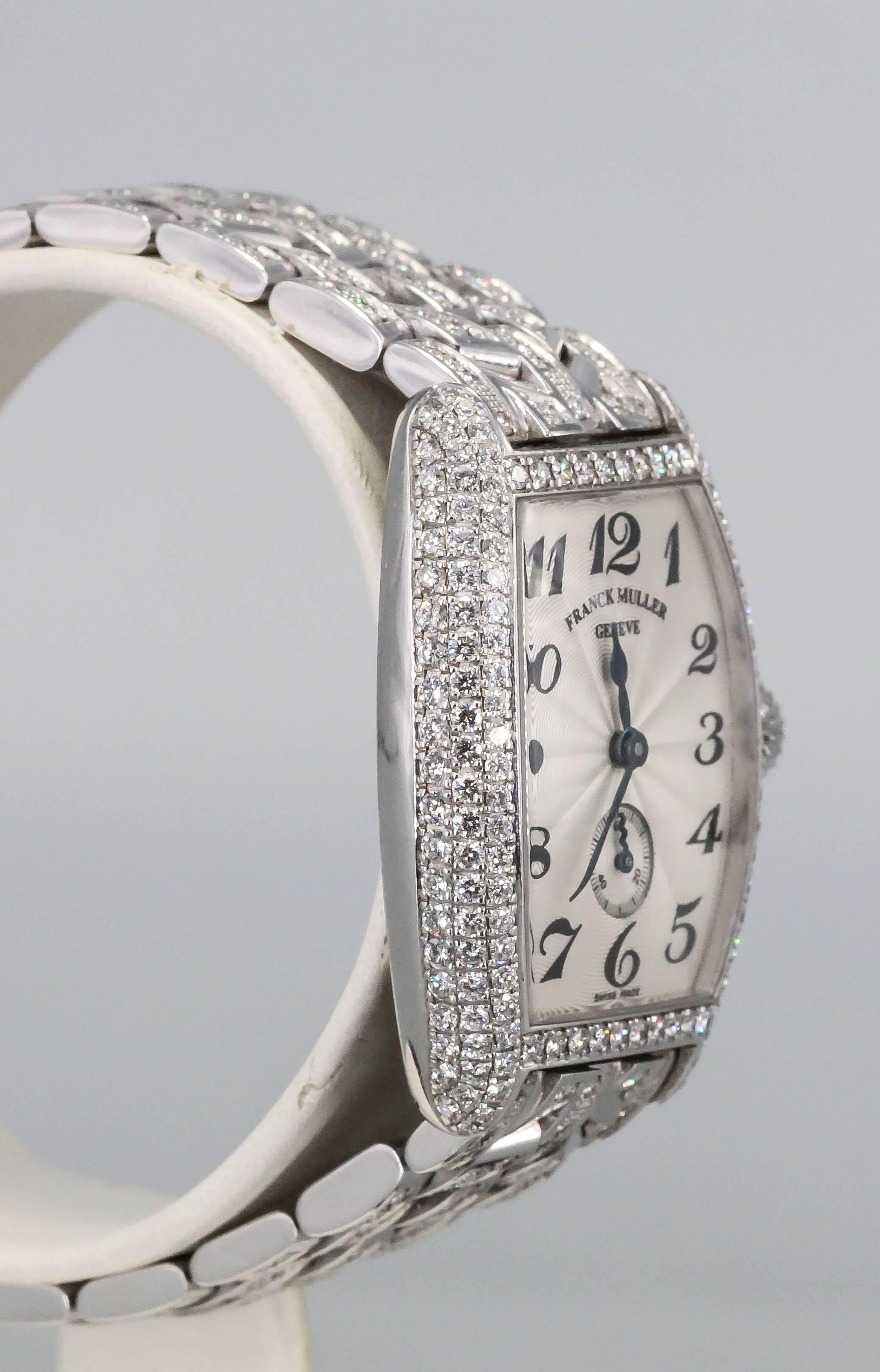 Elegant diamond and 18K white gold ladies wristwatch by Franck Muller. It features a full diamond bezel, loaded with high grade round brilliant cut diamonds, and along the matching bracelet. Manual wind movement and arabic numerals on the dial.