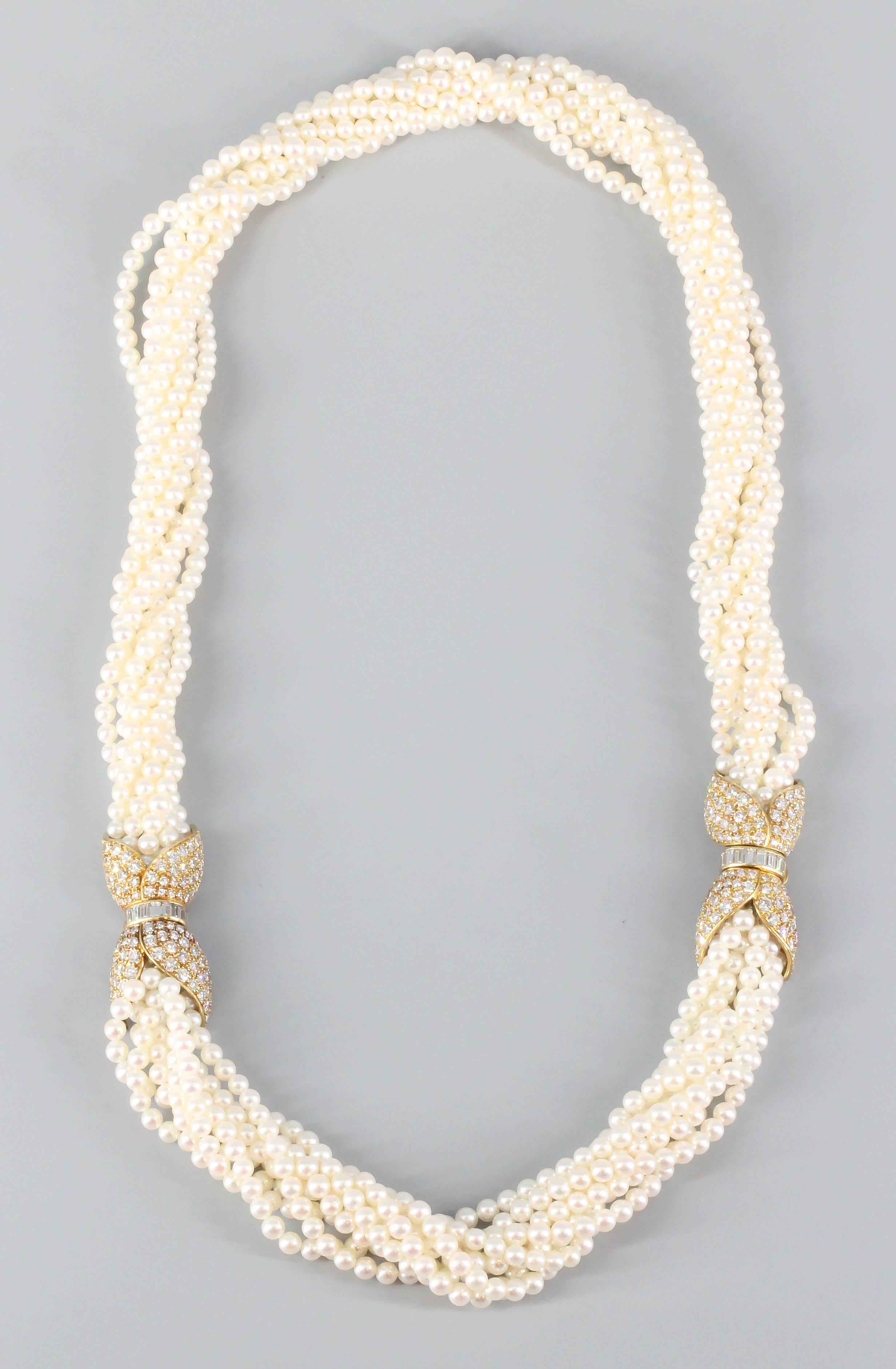 Chic diamond, 18K yellow gold and pearl torsade necklace and bracelet combination by Van Cleef & Arpels. It features 8 strands of lustrous pearls, held on by two clasps (each of which completes the necklace and the bracelet, or can be combined to