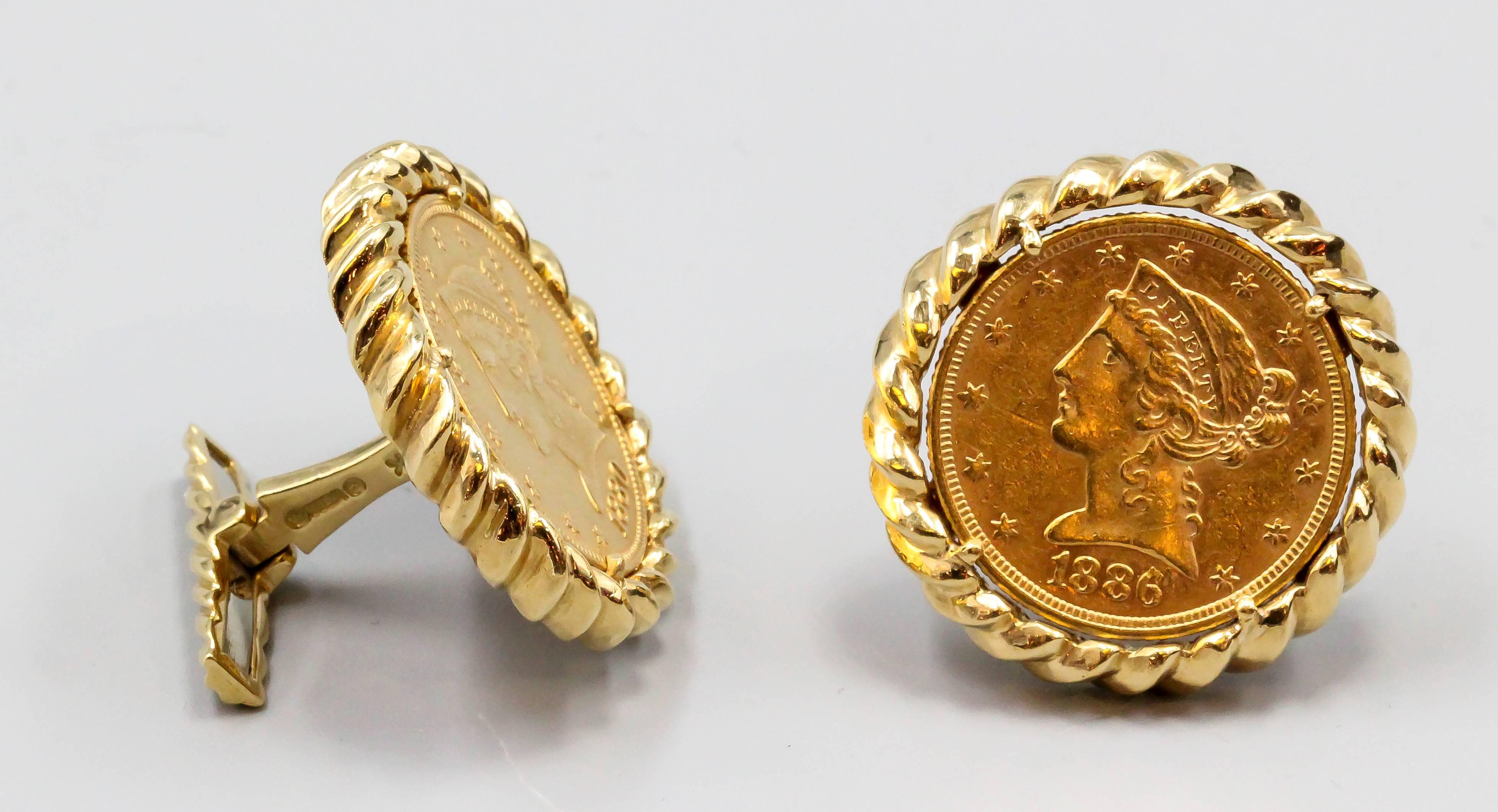 Handsome 18K yellow gold coin cufflinks by David Webb. They feature 1880s $5 Liberty Head coins, one date 1880, the other 1886. Both in superb condition, mounted on a twisted rope style setting. Beautifully made and highly collectible.

Hallmarks: