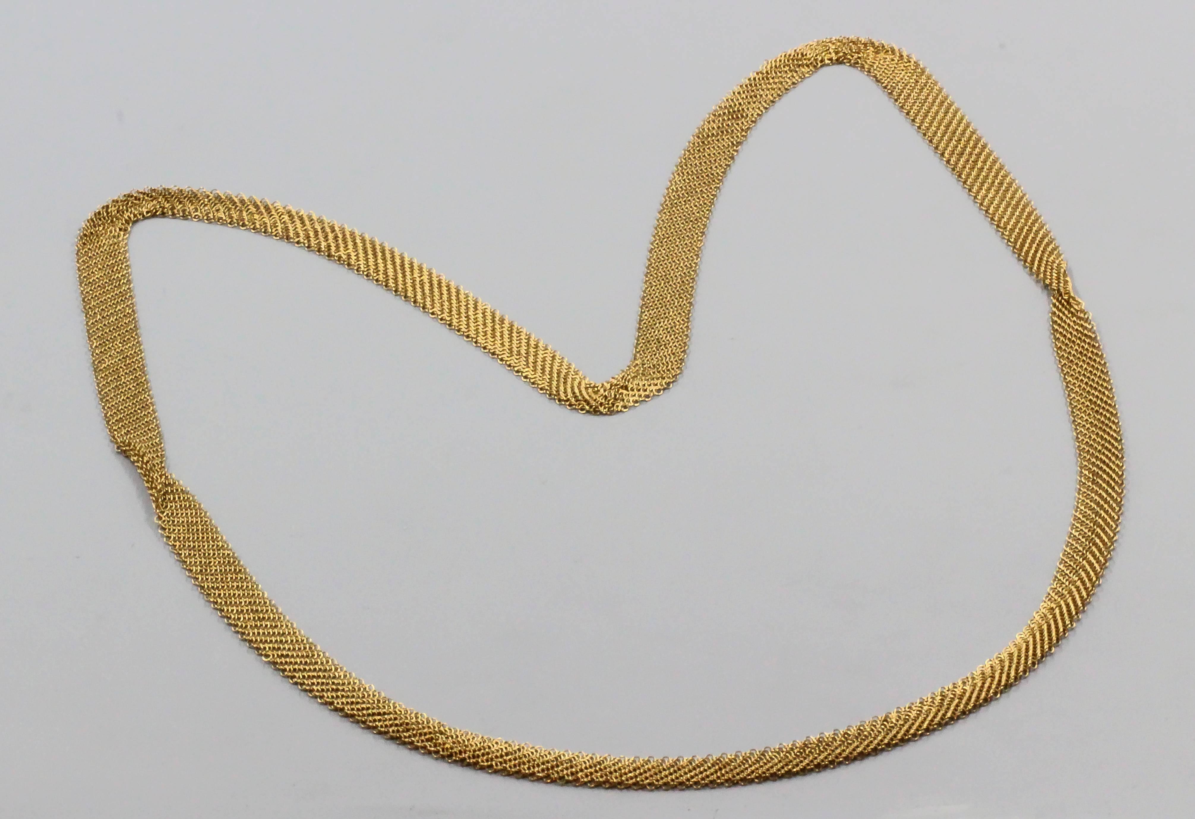 Elegant 18K yellow gold long mesh necklace by Tiffany & Co. Elsa Peretti. It features a beautifully made mesh design and is very versatile, able to be worn as a long chain or choker.

Hallmarks: T & Co., 750, Peretti.