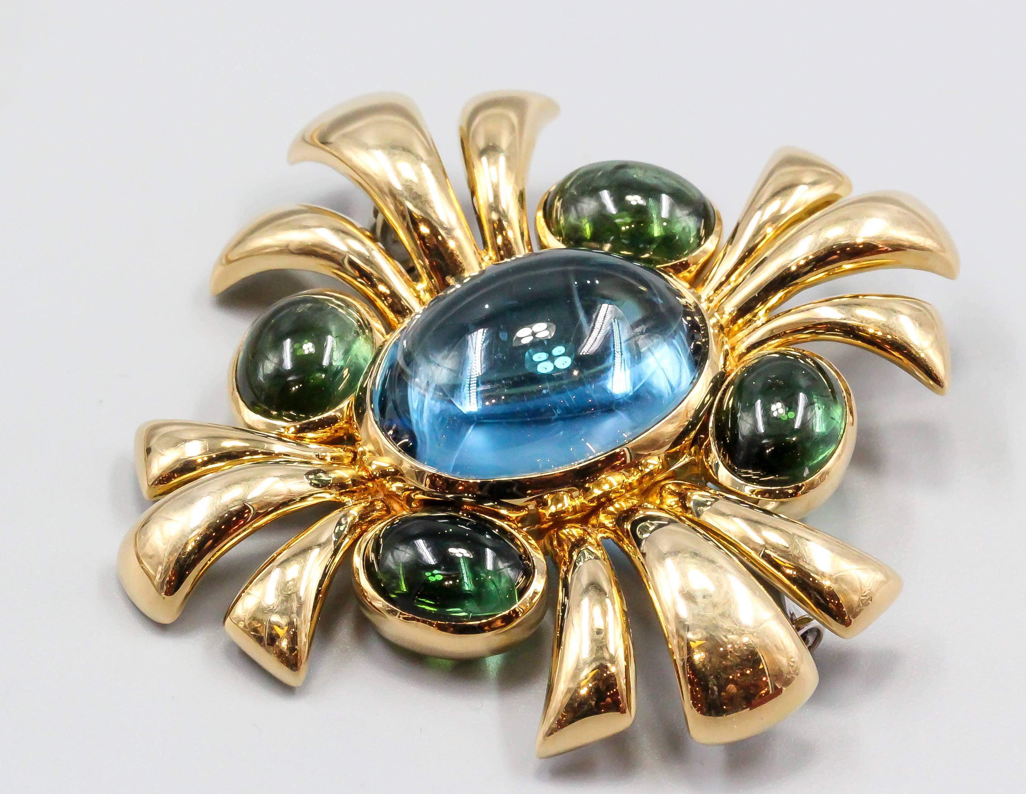 Chic and refined blue topaz, green tourmaline and 18K yellow gold brooch from the 