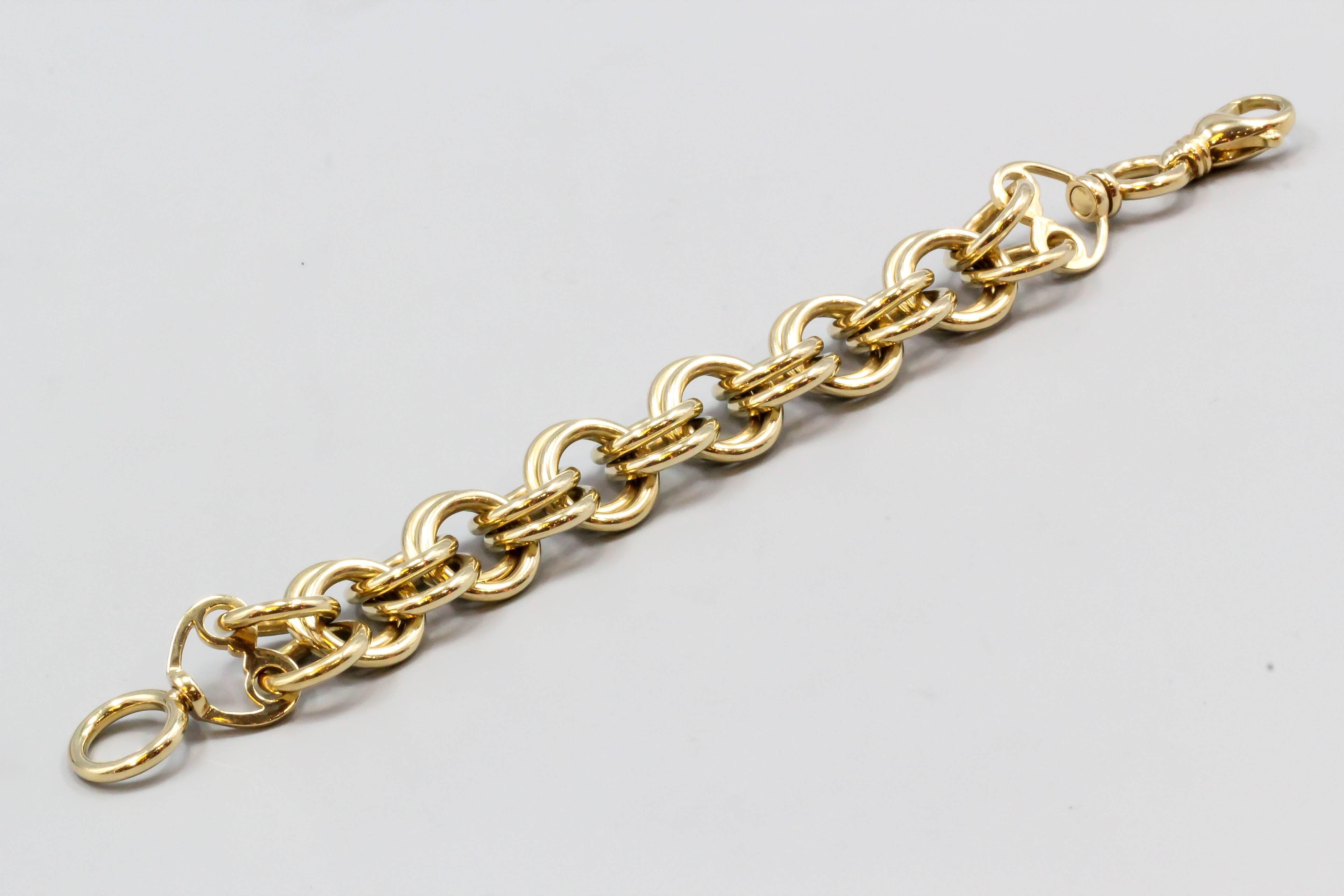 Elegant 18K yellow gold link bracelet by Tiffany & Co. Schlumberger.  It features doubled up hoops linked together with a large lobster claw clasp. Perfect for adding various larger charms and very versatile. Beautiful workmanship. Retail price