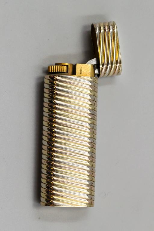 Elegant 18K yellow, white and rose gold ribbed lighter from the 
