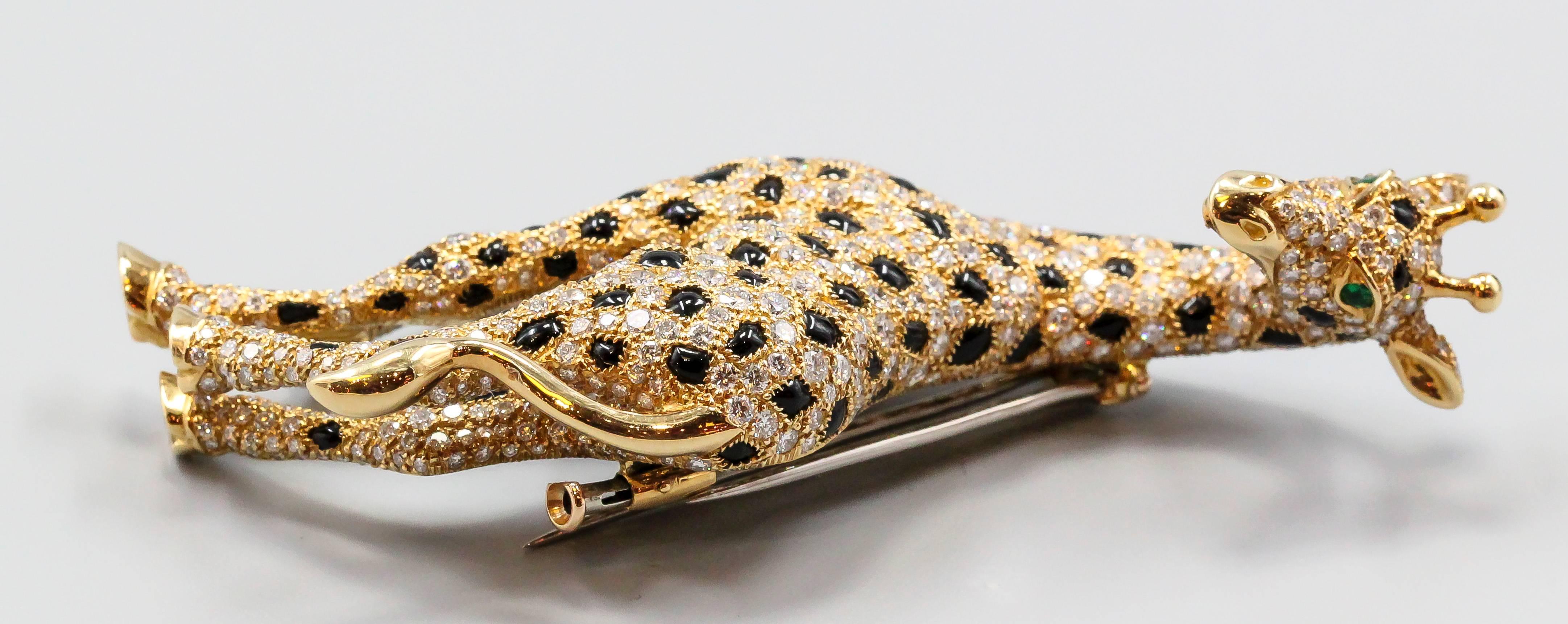 Rare and unusual diamond, emerald, onyx and 18K yellow gold brooch by Cartier. It resembles a giraffe, with high grade round brilliant cut diamonds throughout the body, black onyx spots, emerald eyes and 18K gold setting. Absolutely stunning piece,