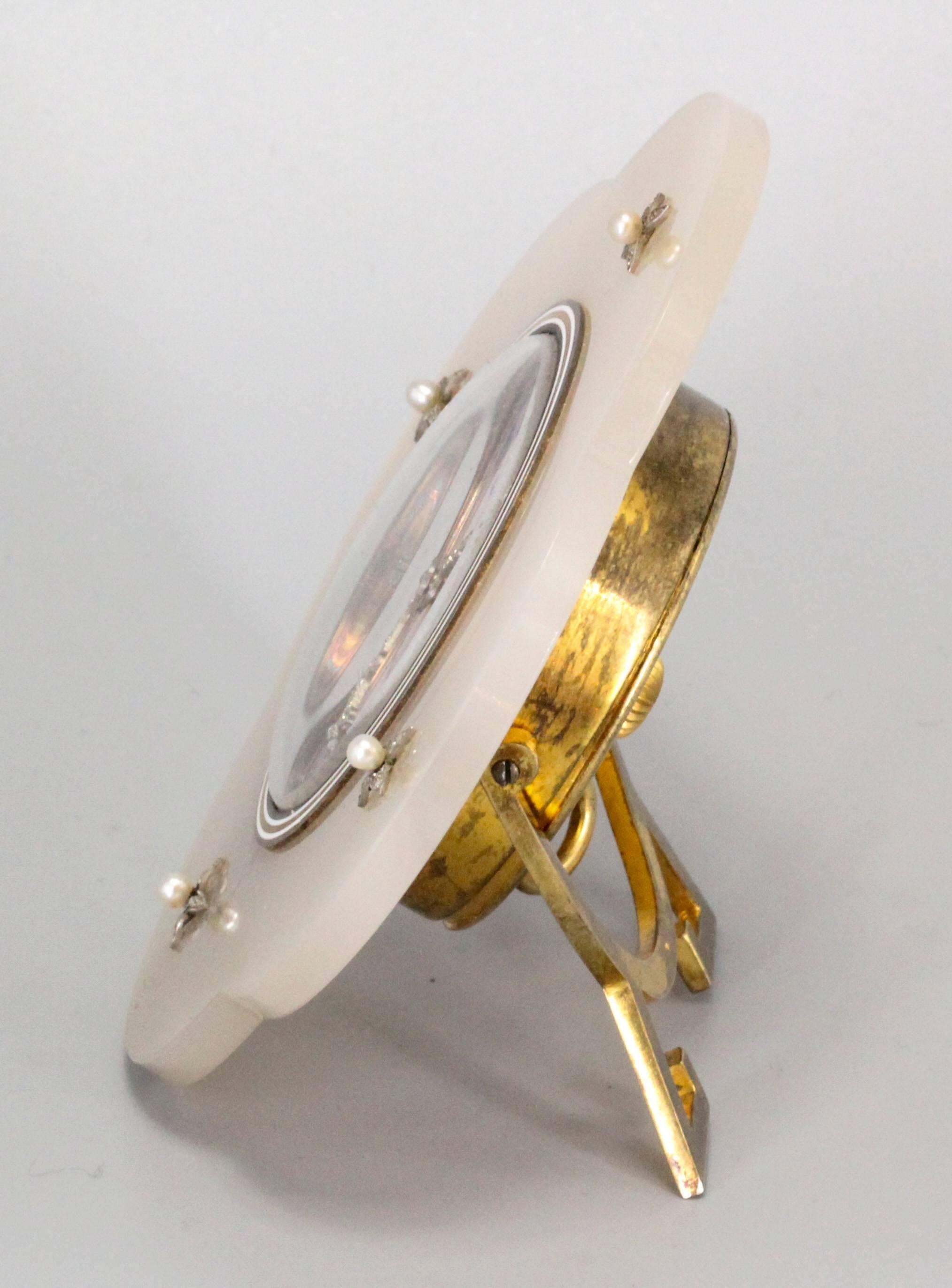 Rare and unusual Art Deco bedside clock by Ugo Frilli. It features an enamel face, with diamonds set platinum hands. Body is made of agate, with small seed pearl accents along with diamonds around them set in platinum, the case made in gilt silver.