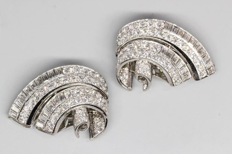Chic and impressive diamond and platinum double clip brooch by Tiffany and Co., circa 1935. The clip was made by Oscar Heyman for Tiffany & Co. as is apparent by the side detail of each clip. It features approx 20 carats of high grade round and