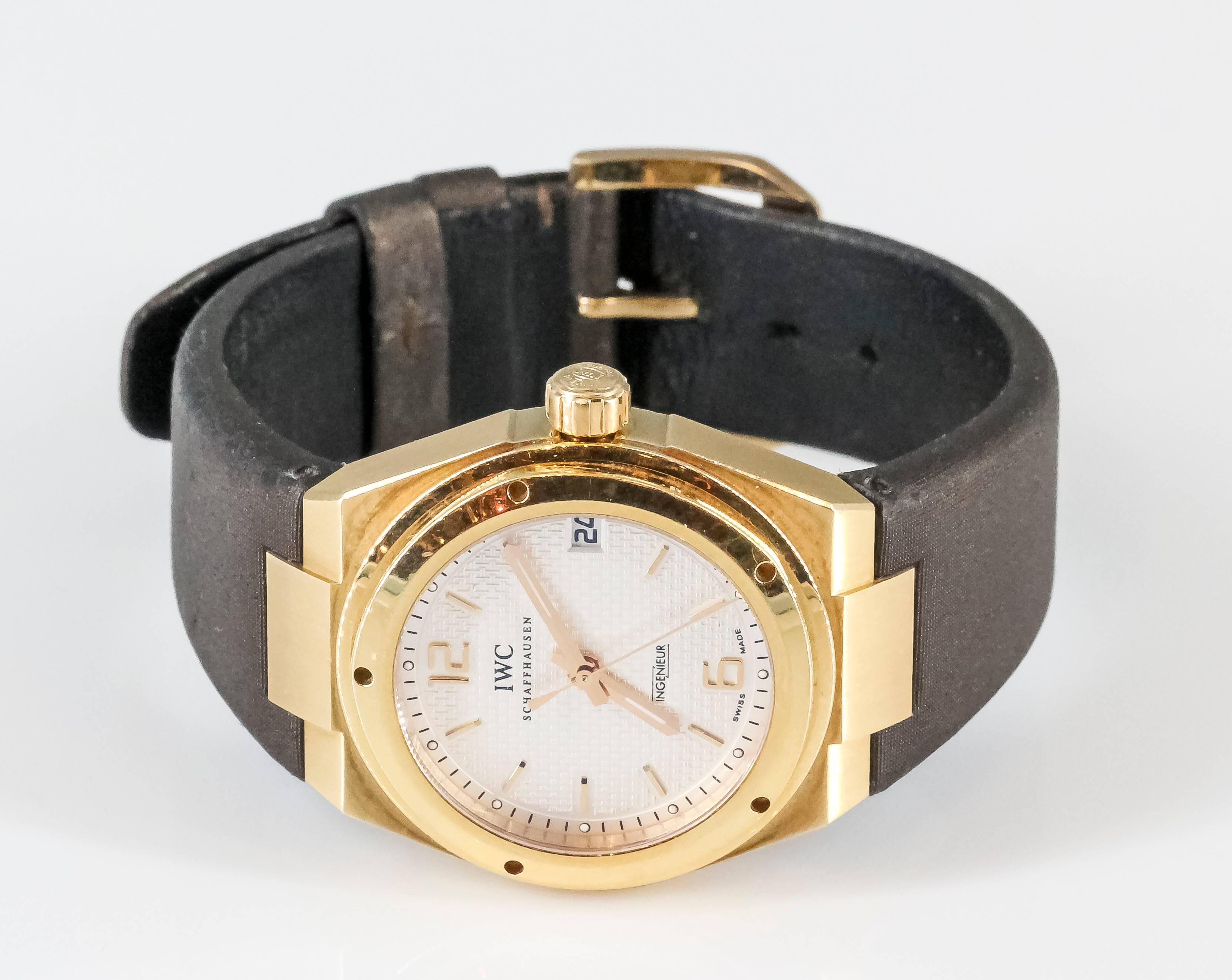 Handsome 18K yellow gold wrist watch from the "Ingenieur" collection by IWC. It features a bold and simple design, with hidden lugs, date at 3 o'clock and numbers at 12 and 6. Unisex design can be worn by men or women. Features 18K gold