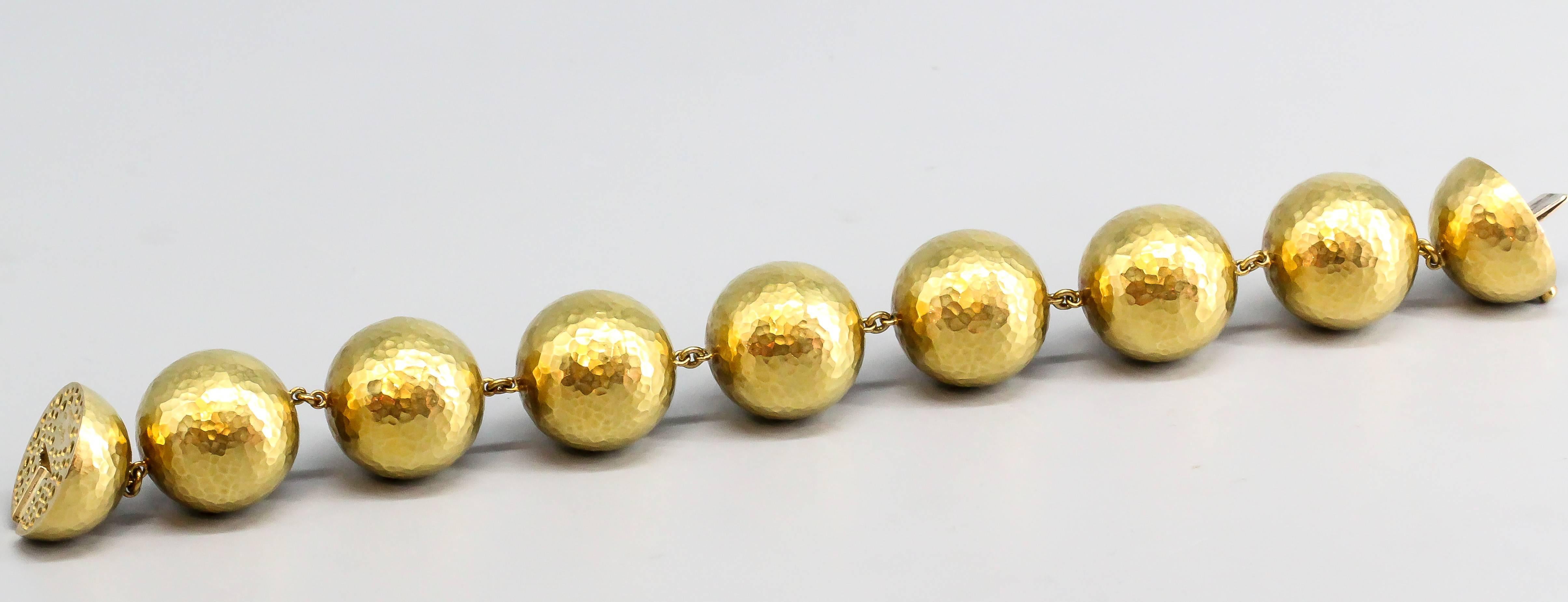 Impressive and bold sphere and link bracelet by Paloma Picasso for Tiffany & Co., circa 1990s.  The stylish bracelet features a hammered gold texture, unlike the more shiny polished gold of modern jewelry.  From the 