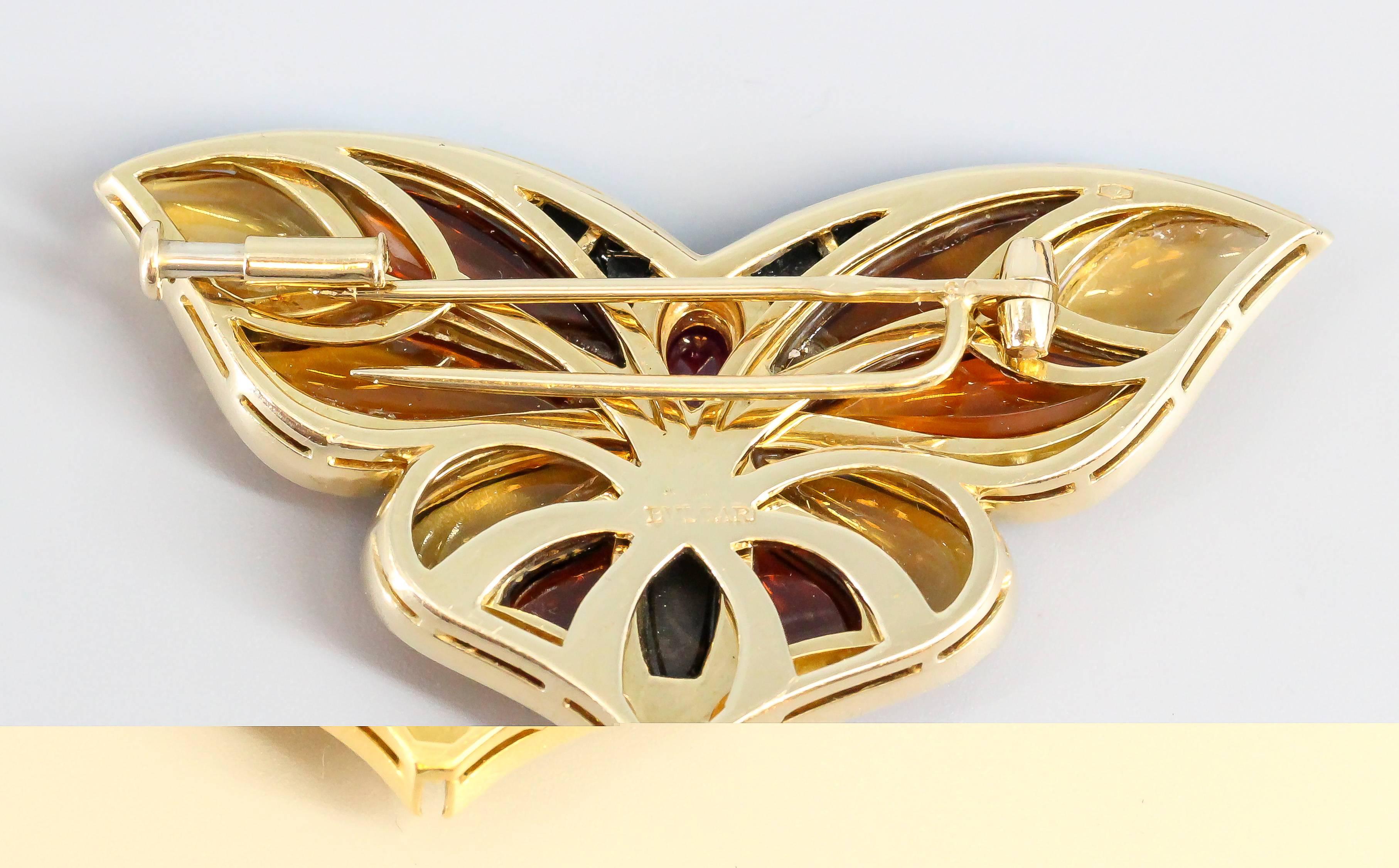 Whimsical diamond, ruby, onyx, citrine and 18K yellow gold brooch by Bulgari, circa 1980s. It resembles the likeness of a butterfly. Also features high grade round brilliant cut diamonds along the ends of the wings. Highly wearable and beautifully
