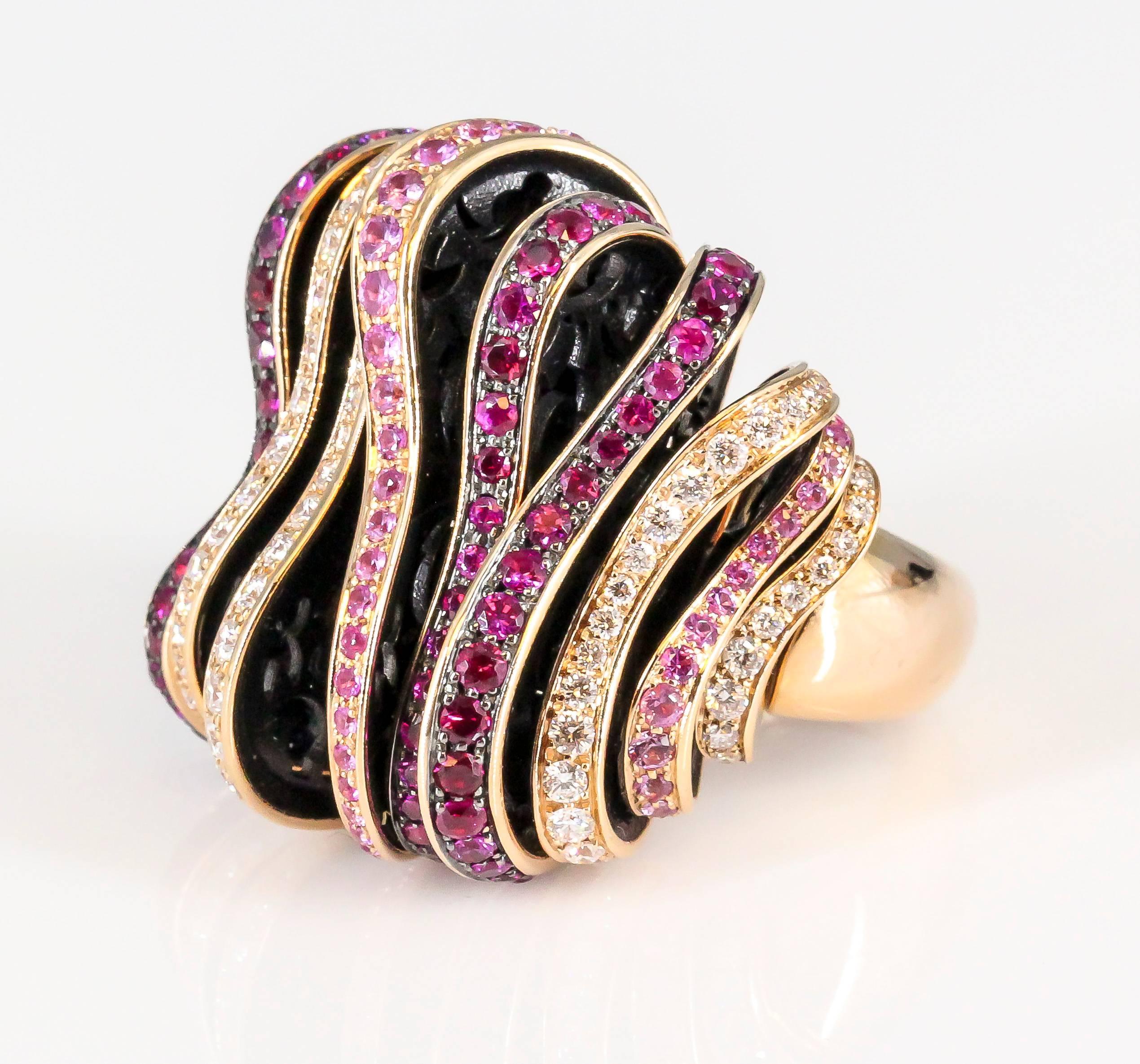 Whimsical pink sapphire, red ruby, diamond and 18K rose gold fashion ring by De Grisogono. It features high grade pink sapphires, rubies and round brilliant cut diamonds throughout, set on gold and black resin piece puzzle sections. Current size 53.