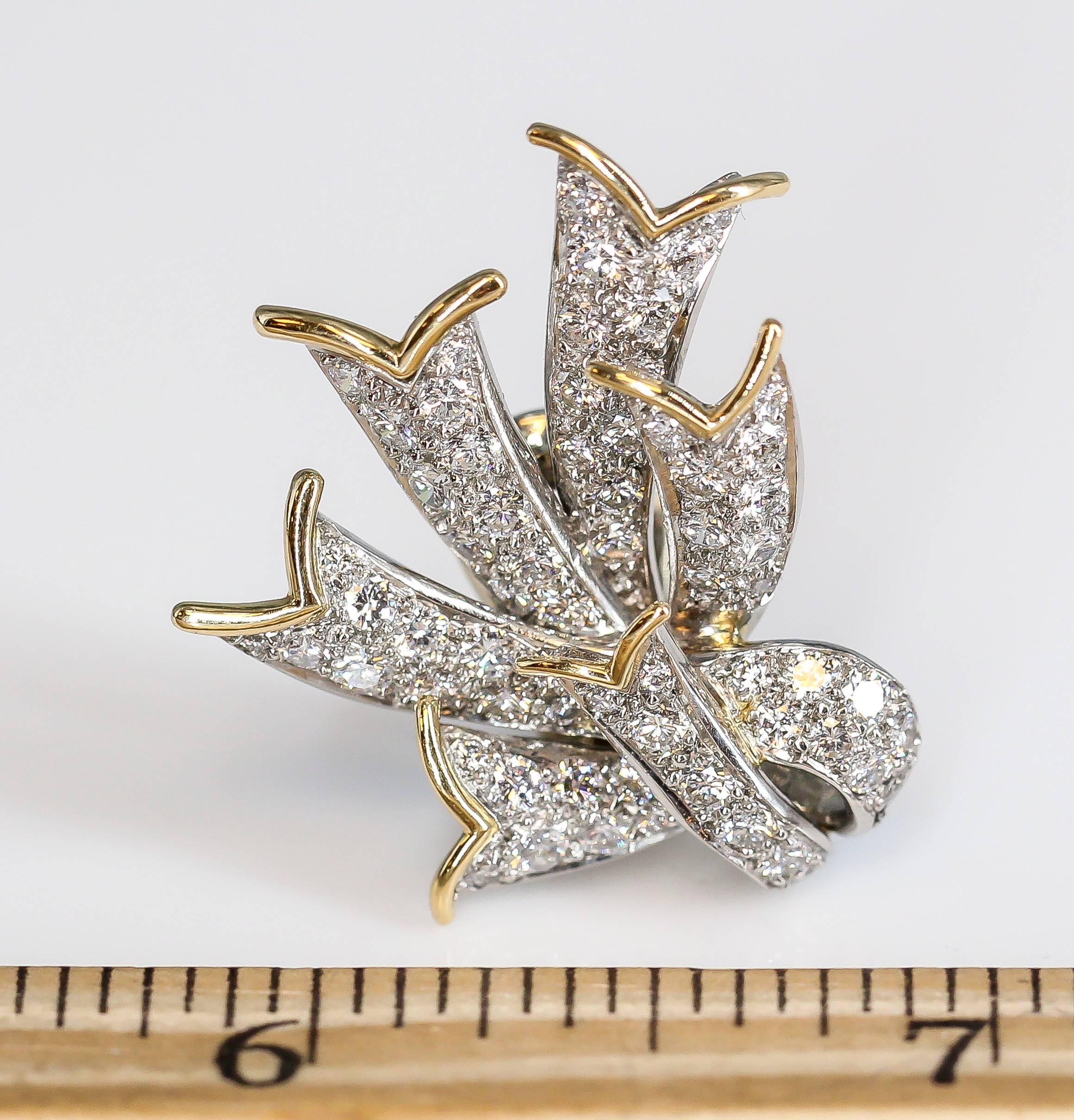 Elegant diamond, platinum and 18K yellow gold ear clips by Tiffany & Co. Schlumberger, circa 1970s. They feature high grade round brilliant cut diamonds throughout, with yellow gold accents, over a platinum setting. Approx. 5 carats of