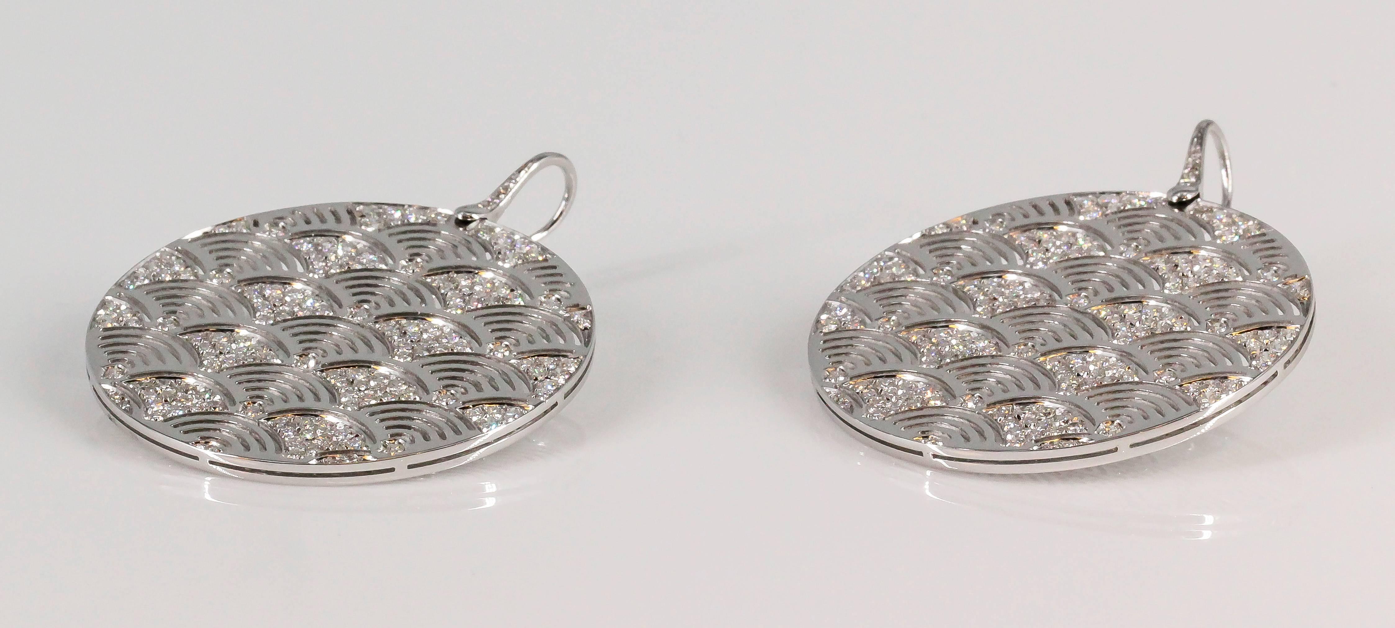 Stylish diamond and 18K white gold drop earrings by Enigma Gianni Bulgari. They resemble circular discs, with high grade round brilliant cut diamonds throughout, over a white gold setting. Diamond weight approx. 6 carats, original retail price
