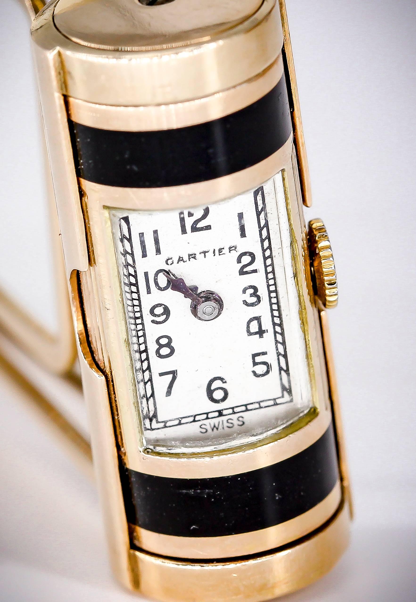 Handsome 14k yellow gold and black enamel money clip with watch built-in by Cartier. Watch swivels on its axis and can be completely concealed. It features roman numerals and a mechanical movement. Money Clip has a very nice yet simple design that