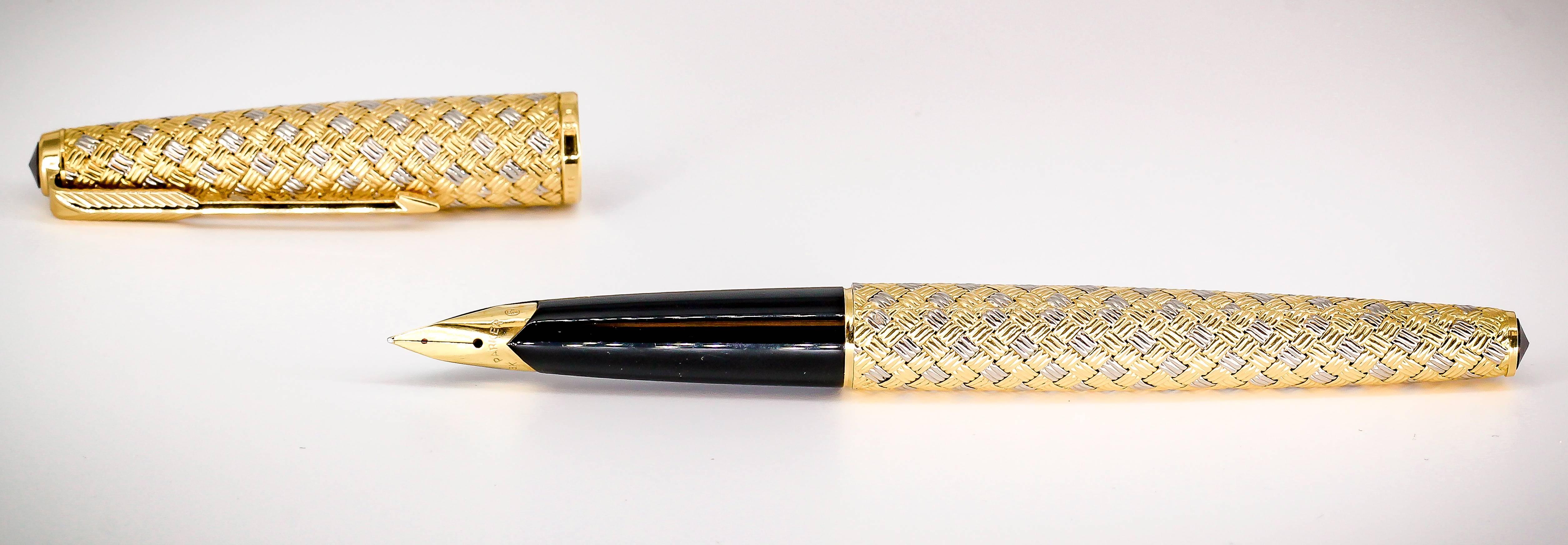 Elegant 18K white and yellow gold fountain pen by Boucheron. It features an intricate basketweave design. Beautiful workmanship and easy to use, carry, or give as a gift.

Hallmarks: Boucheron, Parker, Paris, French 18K gold assay mark.