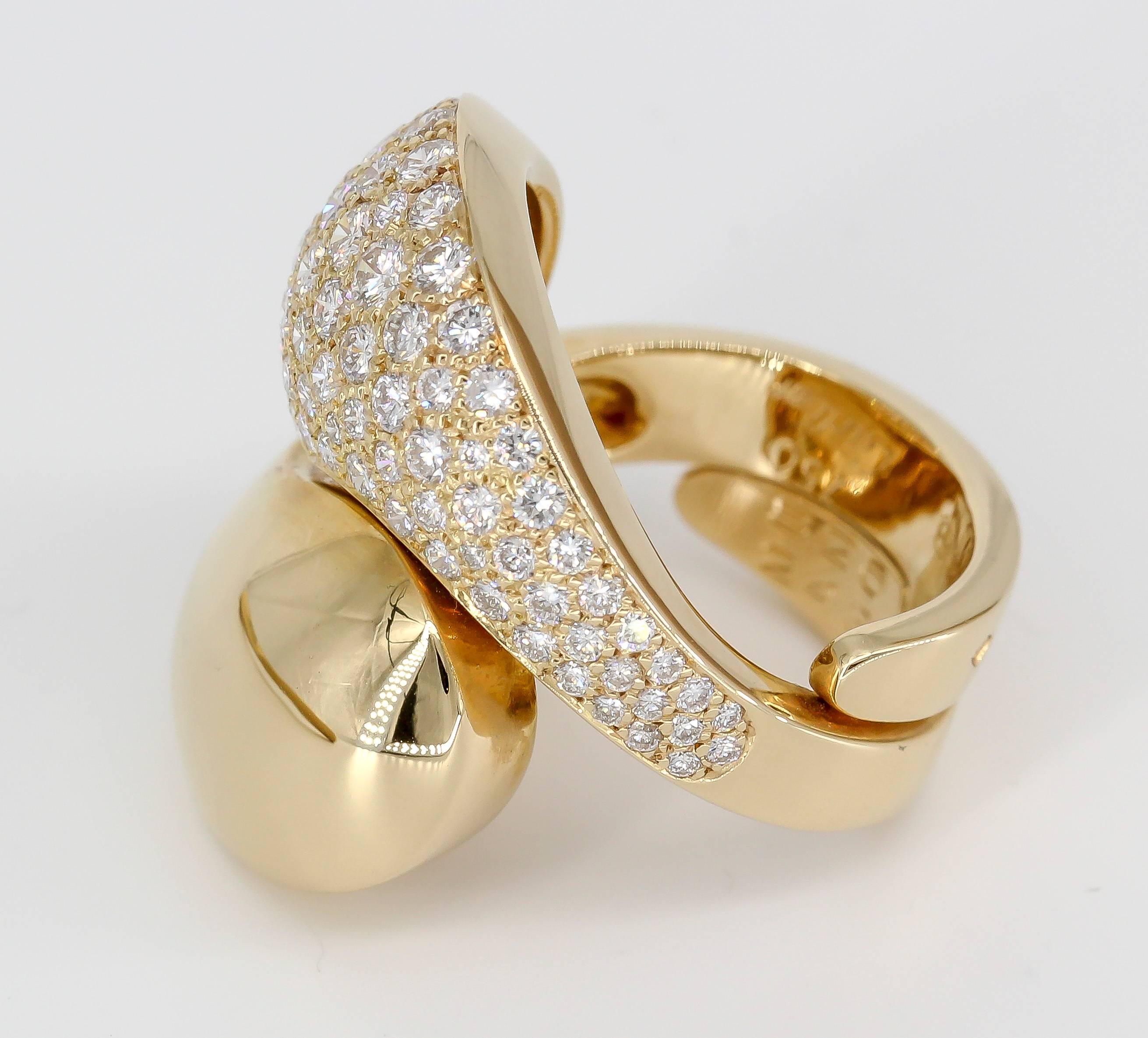 Stylish diamond and 18K yellow gold ring by Cartier. It has a "Yin Yang" motif. Features high grade round brilliant cut diamonds throughout one side. Beautiful workmanship and easy to wear anywhere. European size 48.

Hallmarks: Cartier,
