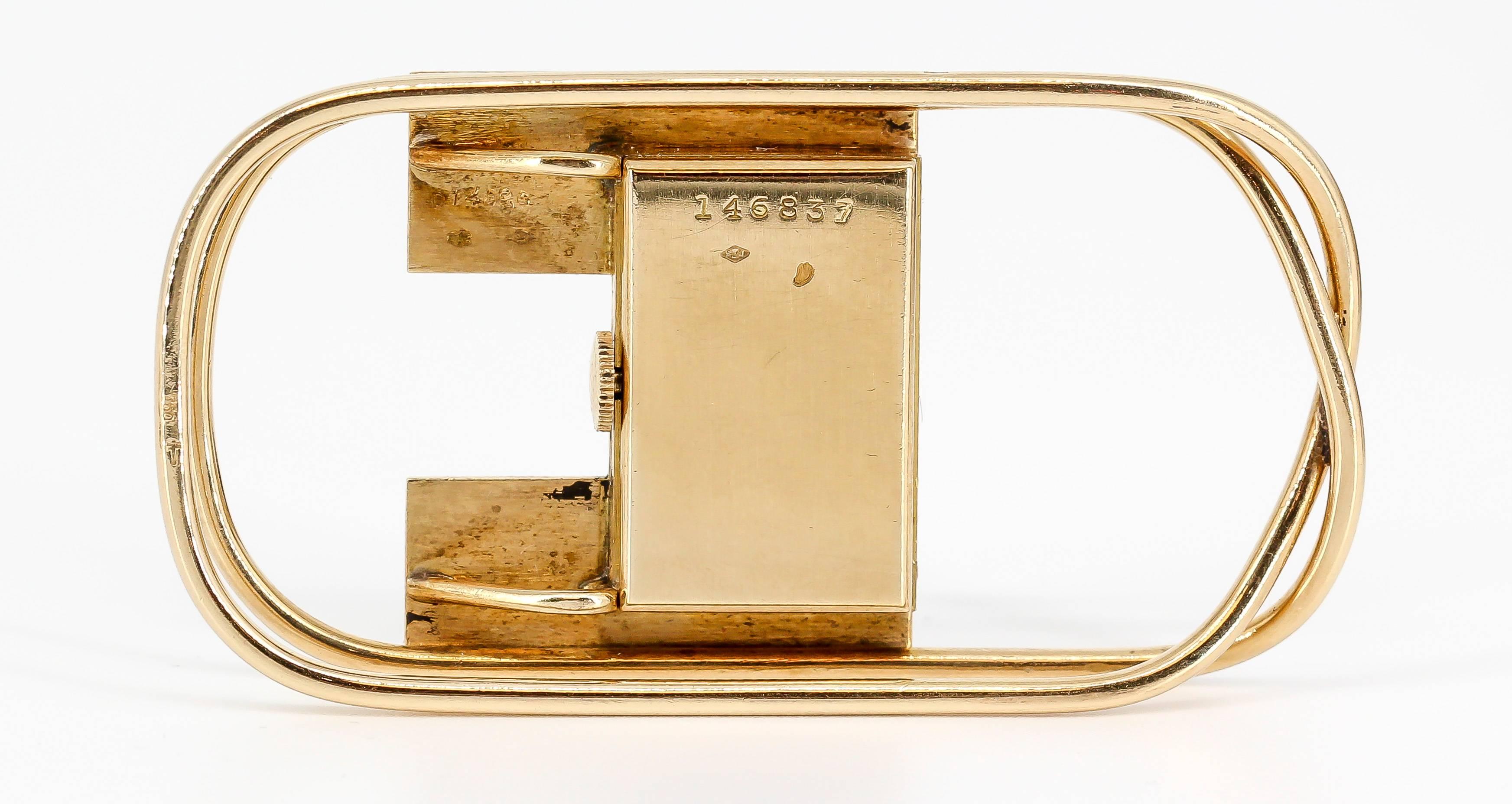 Handsome and very rare French 18K yellow gold money clip with built-in watch by Cartier, circa 1940s. It features a 1/2" diameter clock in the middle of the money clip. Manual wind mechanism by Edmond Jaeger. Expert workmanship