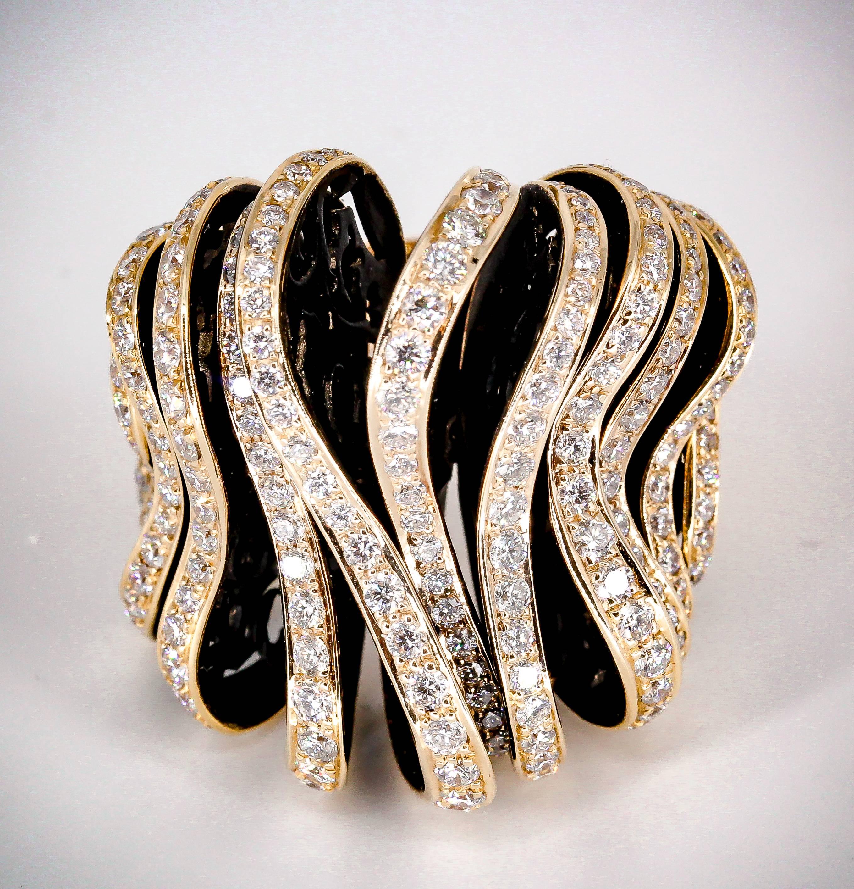 Stunning diamond and 18K rose gold cocktail ring by De Grisogono. It features high grade round brilliant cut diamonds throughout, set on gold and black resin piece puzzle sections. Current size 53. Original retail price approx. $40000.

Hallmarks: