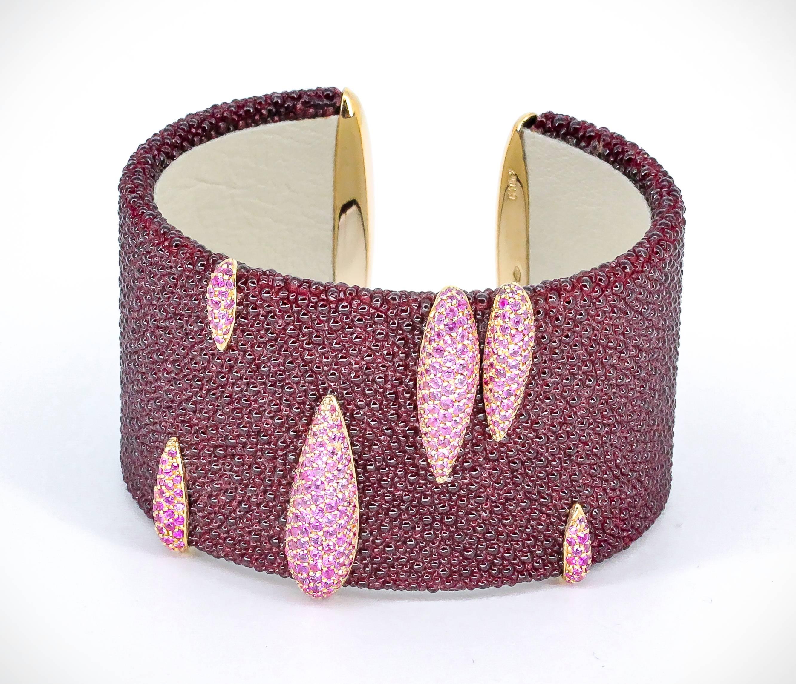 Stylish pink sapphire, yellow 18K gold and stingray bangle bracelet by De Grisogono. It features high grade pink sapphires within yellow gold setting over a burgundy stingray bracelet. Beautifully made with excellent workmanship.  Original retail