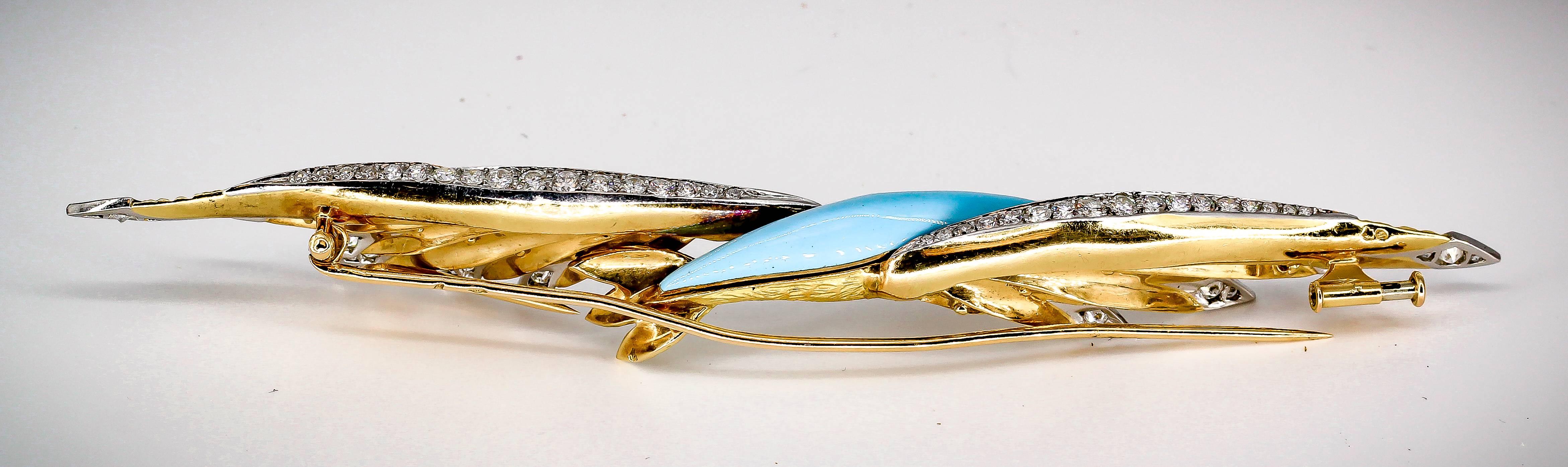 Unusual diamond, enamel, 18K yellow gold and platinum long brooch of French origin, circa 1950s. It resembles a bird with wings spread and high grade round brilliant cut diamonds throughout the tail , top of wings, and wing tips. Also features blue