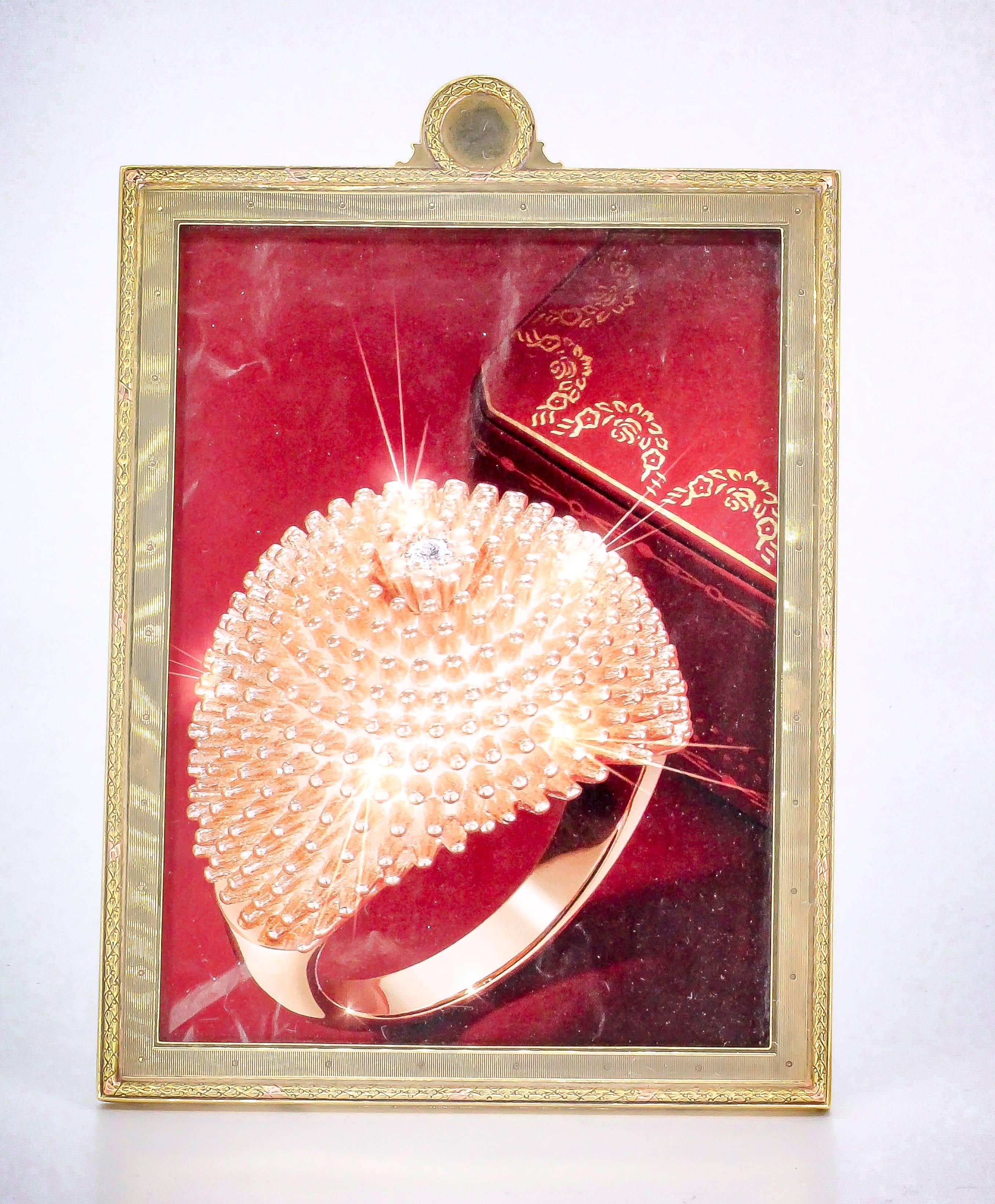 Stylish 14K yellow gold picture frame by Cartier, circa 1930s. Subtly ribbed textured feel with intricate outer edge and crest on top of frame. It will hold a standard 5x7" picture. Beautifully made and an excellent display piece.

Hallmarks: