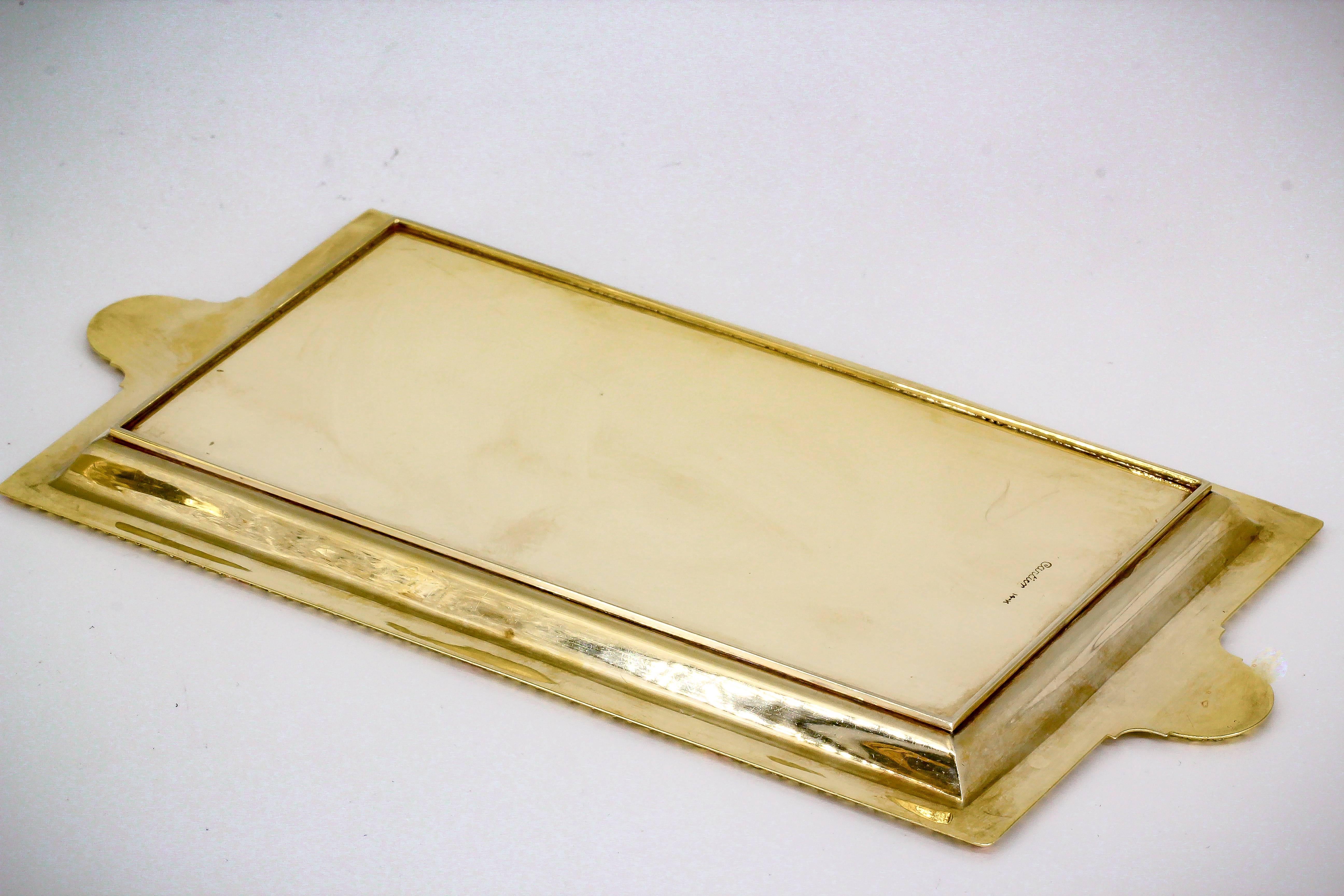 Rare and unusual  14K yellow gold rectangular tray by Cartier, circa 1930s. It features a very subtle ribbed design that feels textured to the touch, with intricate outer edge and thumb holds at sides. Beautifully made and an outstanding display