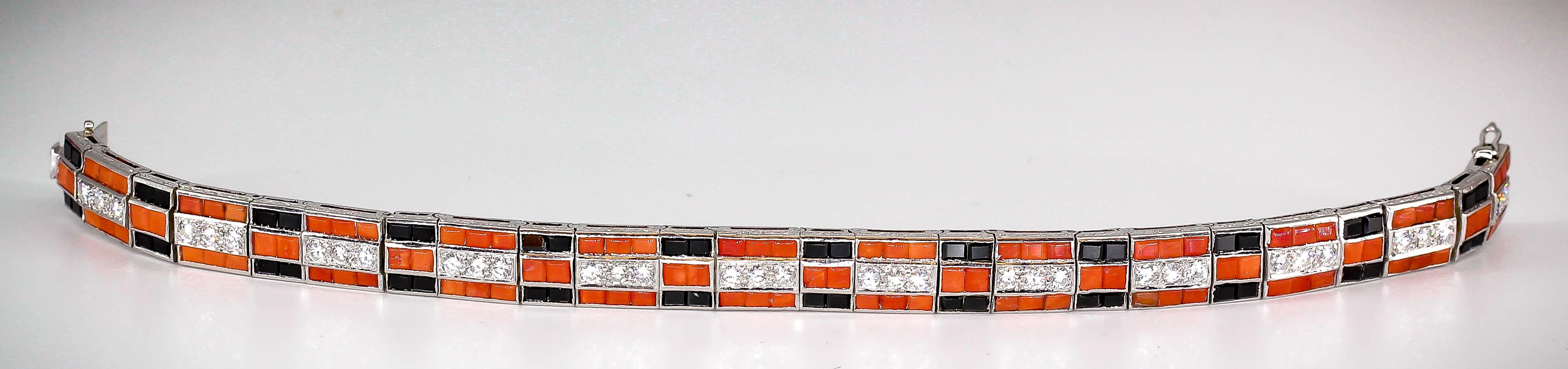 Elegant coral, onyx, diamond and platinum bracelet of the Art Deco era, circa 1920s. It features high grade round brilliant cut diamonds in the middle, surrounded by rich corals and onyx squares over a platinum setting. Beautifully made and very