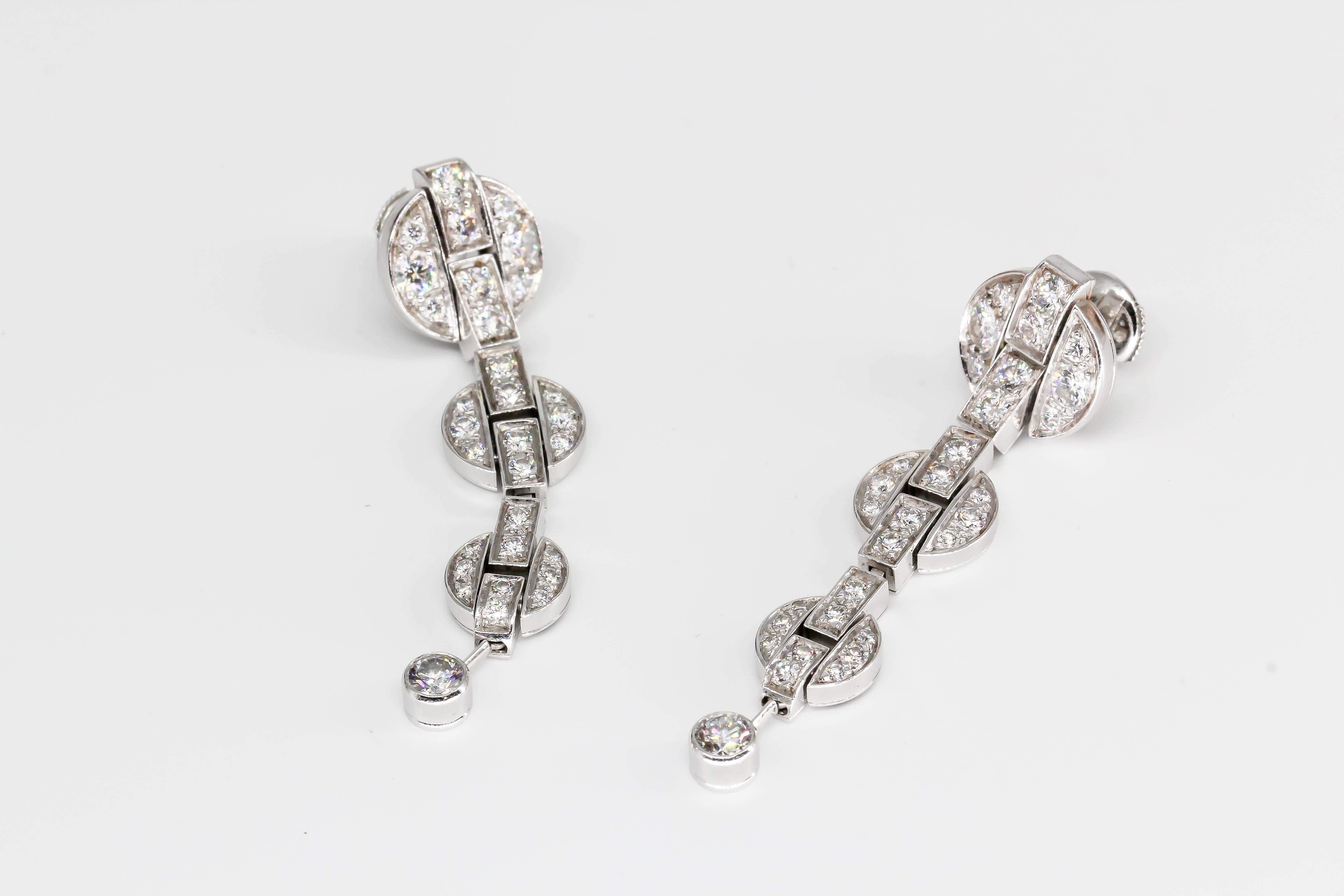 Stylish diamond and 18K white gold drop earrings from the Himalia collection, by Cartier, circa 2006-7. They feature high grade round brilliant cut diamonds, approx. . Beautifully made and very elegant for any occasion.

Hallmarks: Cartier, French