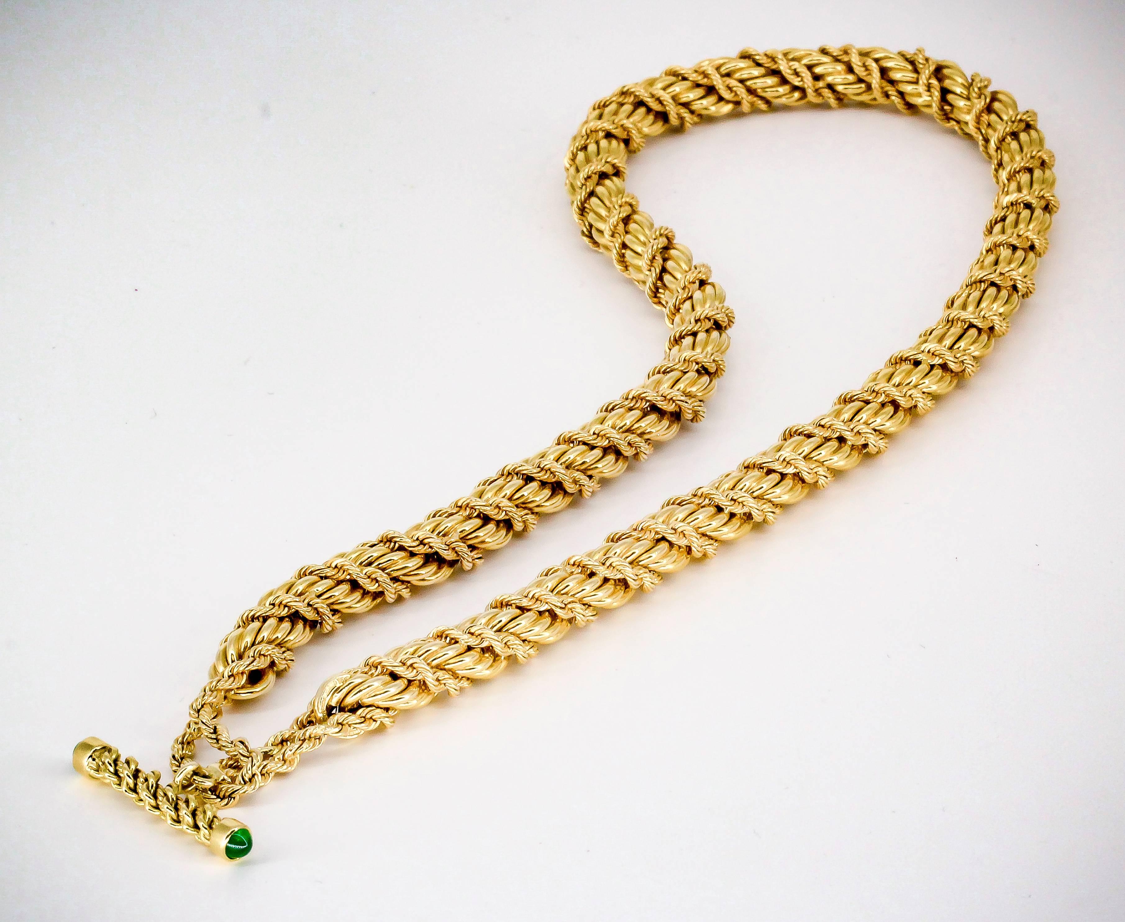 Rare and unusual emerald and 18K gold necklace by Tiffany & Co. Schlumberger, circa 1990s. Necklace feature a large twisted rope, with intertwined twisted rope design; as well as a toggle closure with the bar set with rich green cabochon