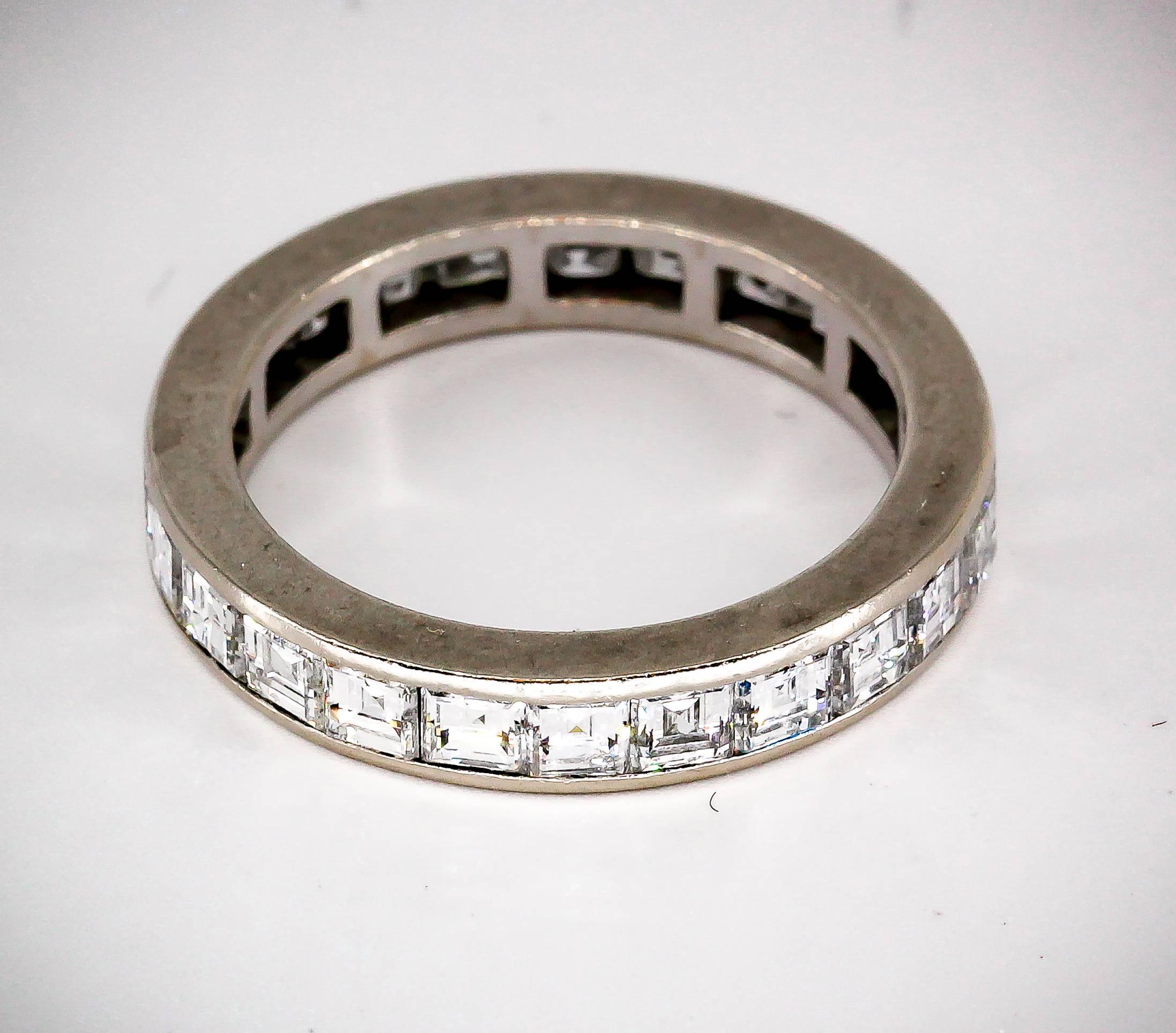 Chic diamond and 18K white gold band by Gubelin. It features 24 high grade square cut diamonds in a channel setting, approx. 3.0 carats of F-G color VVs-Vs clarity diamonds. Size 8.

Hallmarks: Gubelin maker's mark, 750.