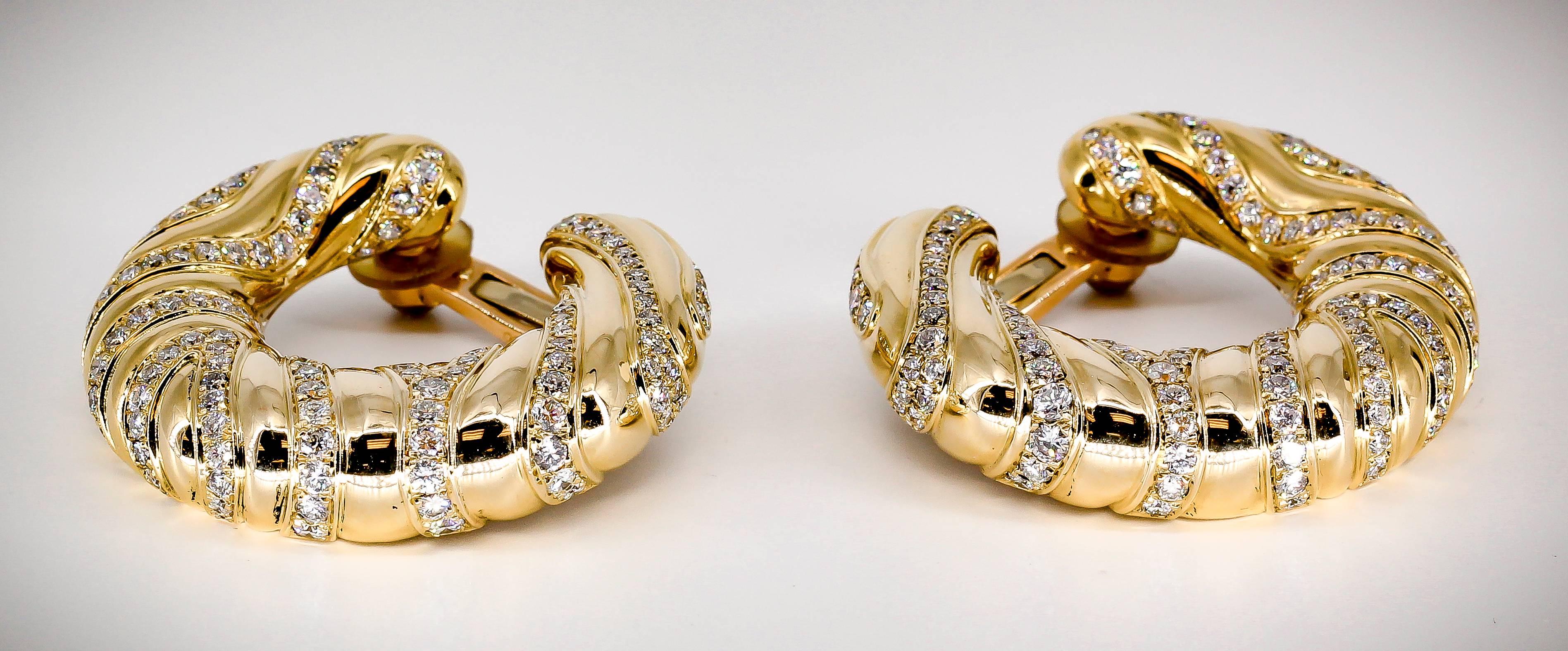 Bold diamond and 18K yellow gold hoop earrings by Cartier. They feature high grade round brilliant cut diamonds throughout, approx. 7-8 carats total weight. 

Hallmarks: Cartier, 750, reference numbers.