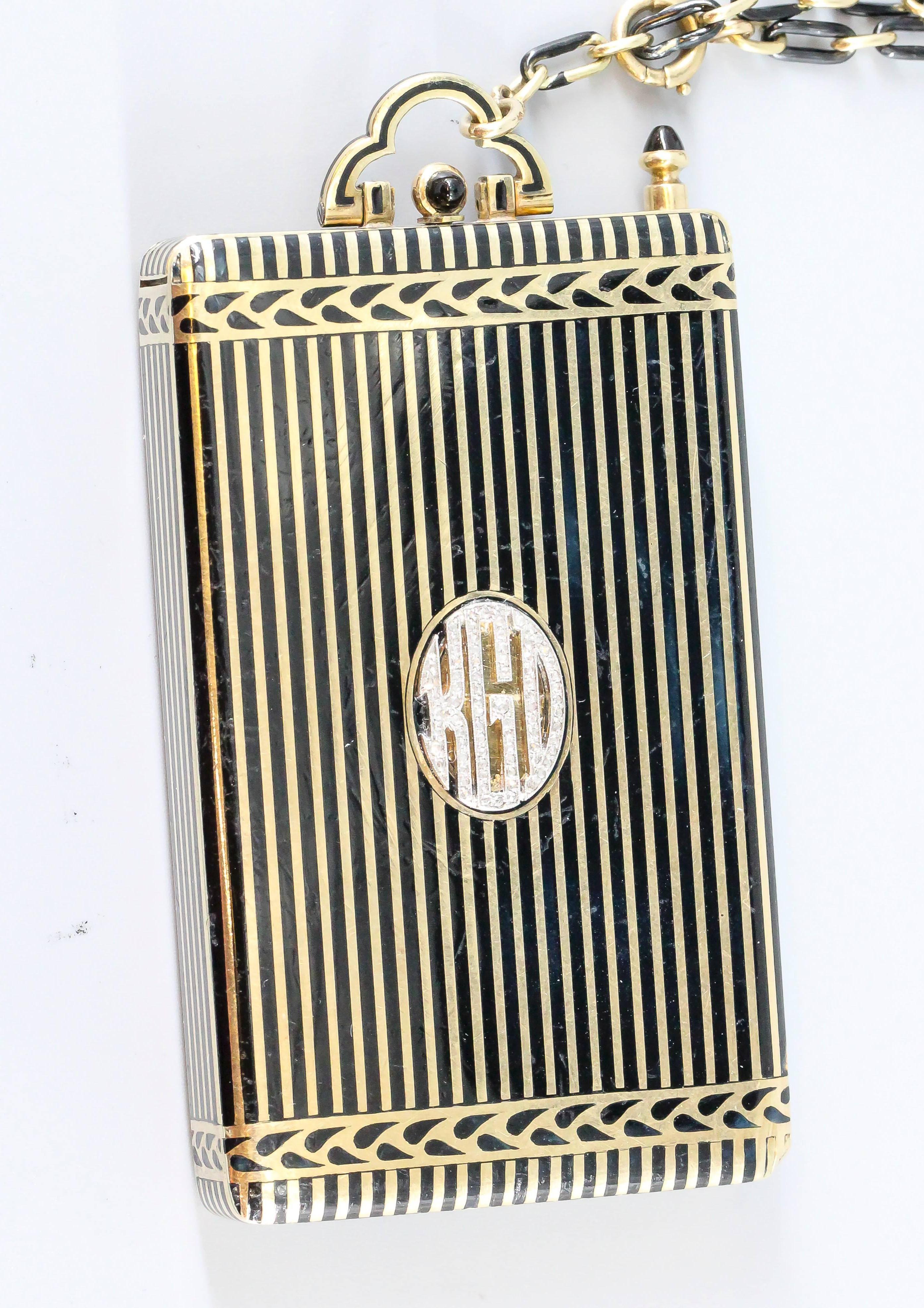 Rare and unusual Art Deco 14K gold and black enamel minaudiere by Cartier, circa 1930s. It features a compact, lipstick case, notepad holder and pencil. Also features platinum and diamond initials 