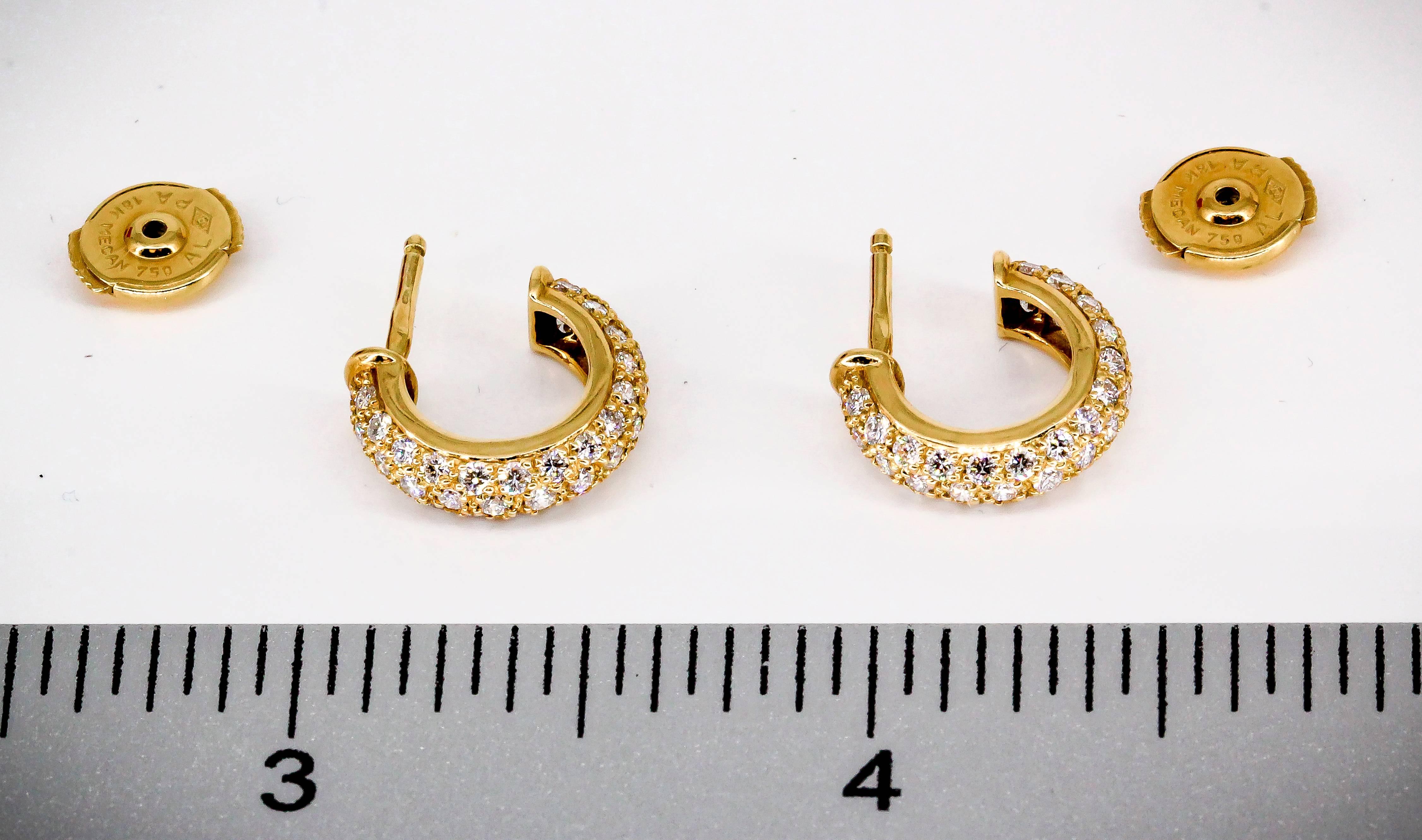 Classic diamond and 18K yellow gold earrings from the "Mimi" collection by Cartier. They feature very high grade round brilliant cut diamonds, approx. 1.0cts total weight.
Hallmarks: Cartier, reference numbers, maker's mark, French 18K