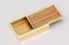 Boîte à pilules coulissante en bois et or de Gubelin