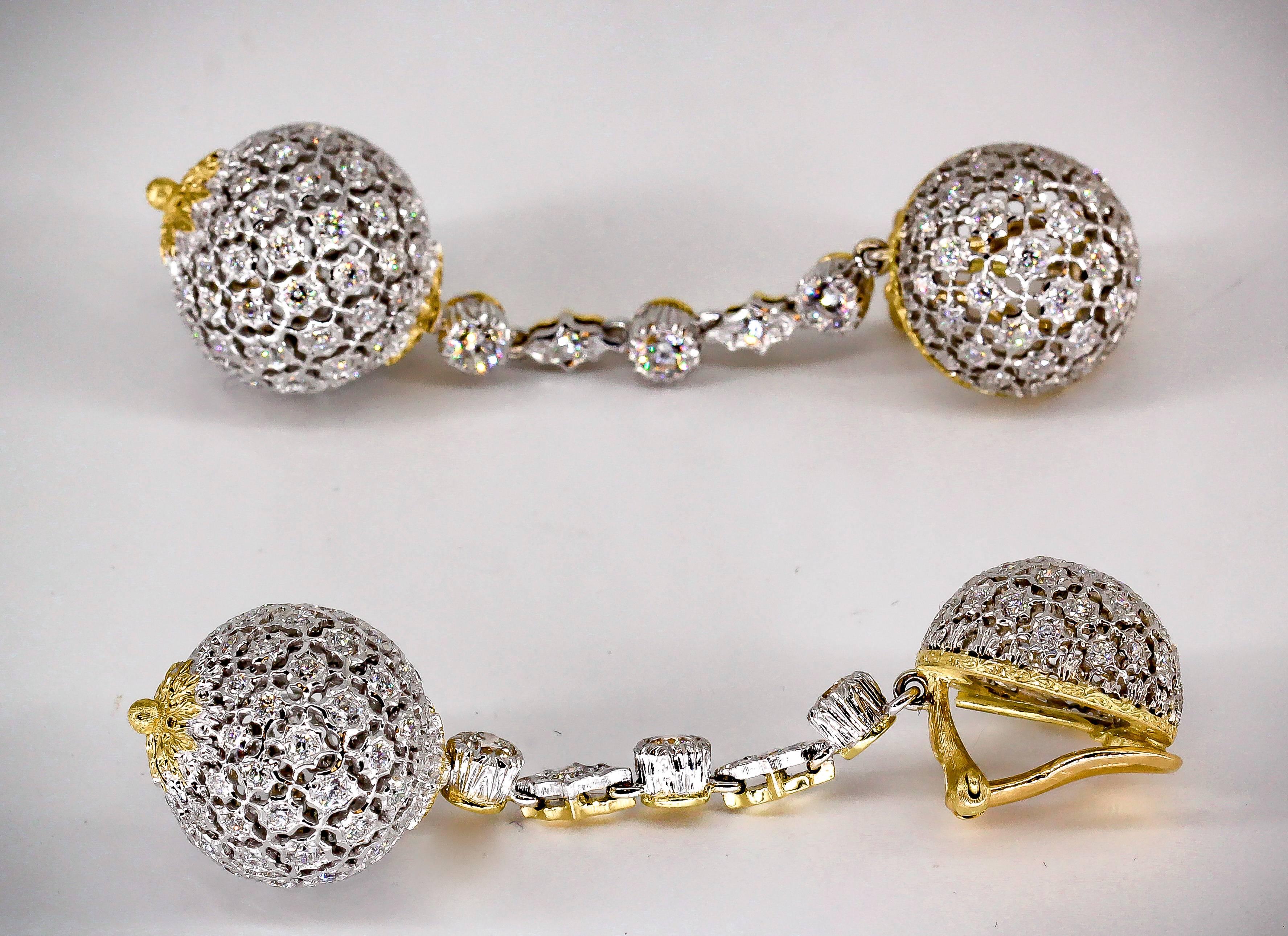 Stylish diamond and 18K yellow gold dangle earrings by Mario Buccellati, circa 1950s-60s. They feature high grade round brilliant cut diamonds throughout, and are in the shape of two spheres held together by a thin string of diamonds set in 18K