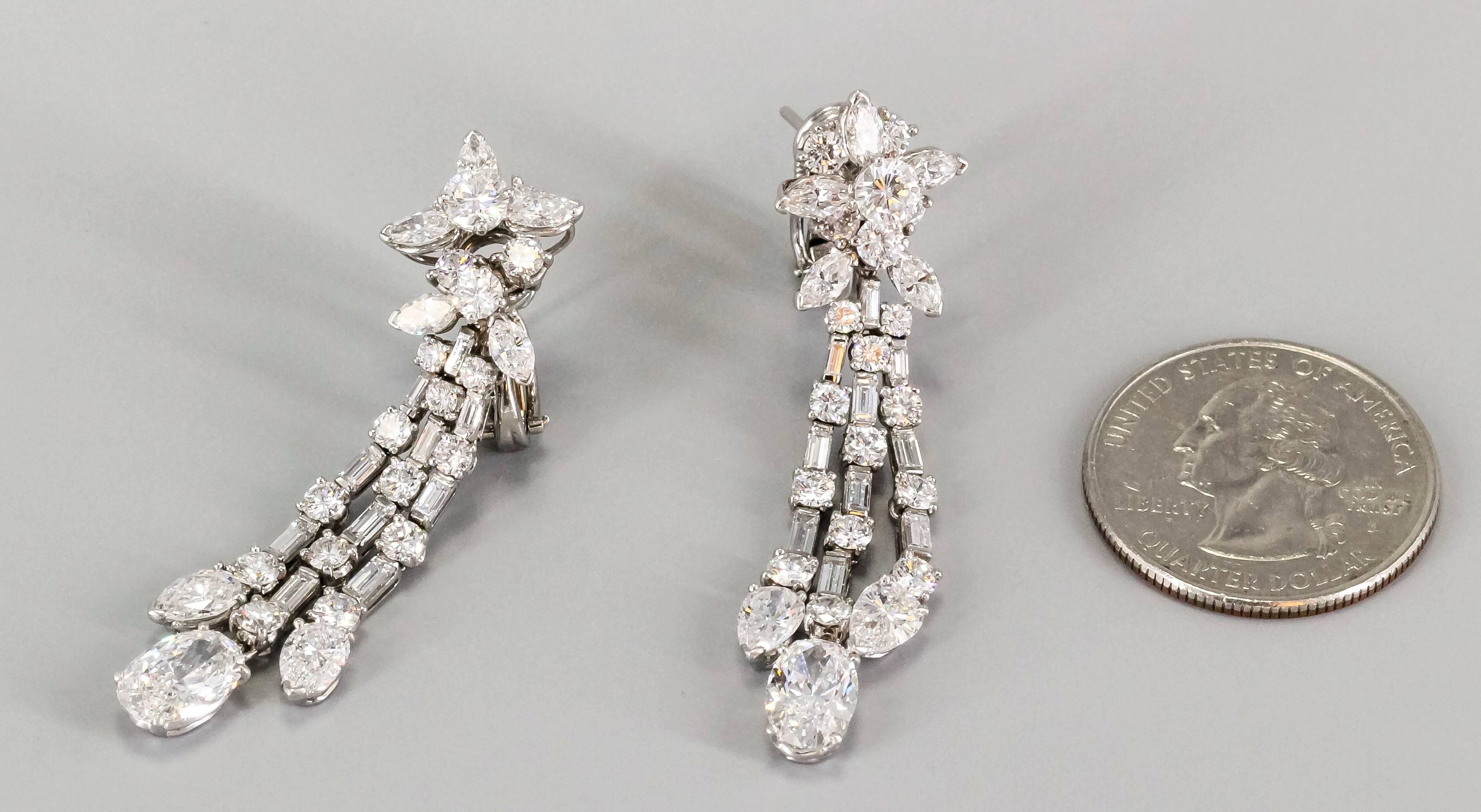 Impressive diamond and platinum ear pendants by Harry Winston, circa 1960s. These wonderful pendant earrings feature very high grade pear, marquise, round and baguette cut diamonds. Overall approx. 10-12cts total weight, ranging from E to F color,