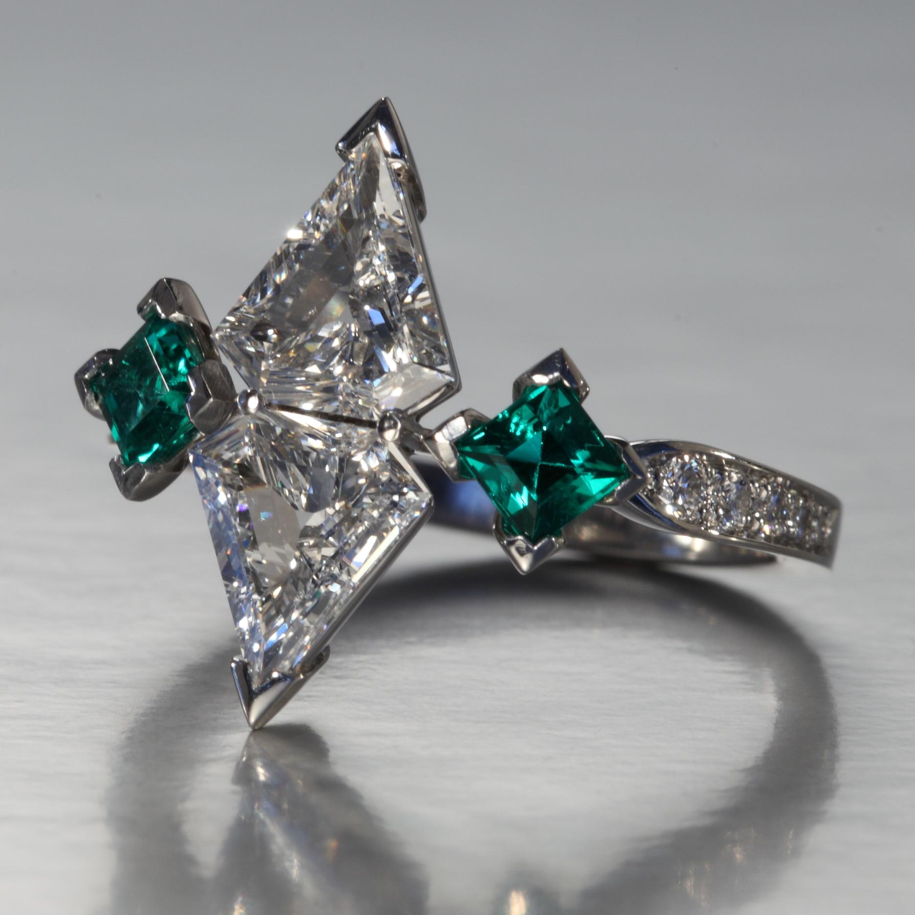 Two kite shaped diamonds with a total of 1.08 carat F,G vvs and two fine green square cut emeralds with a total of 0.39 carat are set with 0.12 carat of small round diamonds F,G vvs in a platinum ring. This one of a kind piece is designed and hand