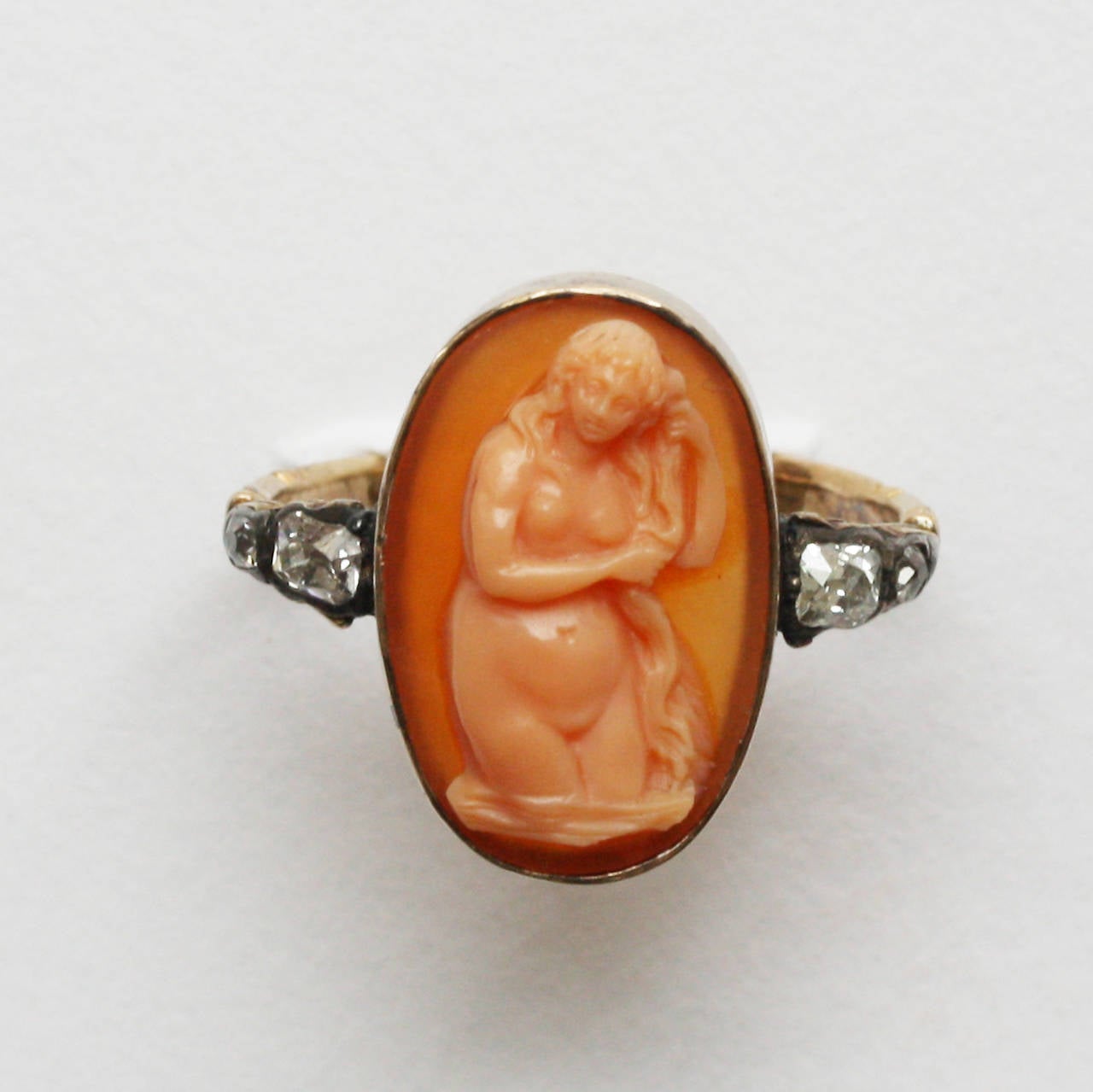 A gold ring set with an agate cameo representing the birth of Venus or Venus Anadyomene, depicting Venus the goddess of love rising from the sea wringing her hair (after the painting by Titian, Venus Rising from the Sea, from the National Gallery of