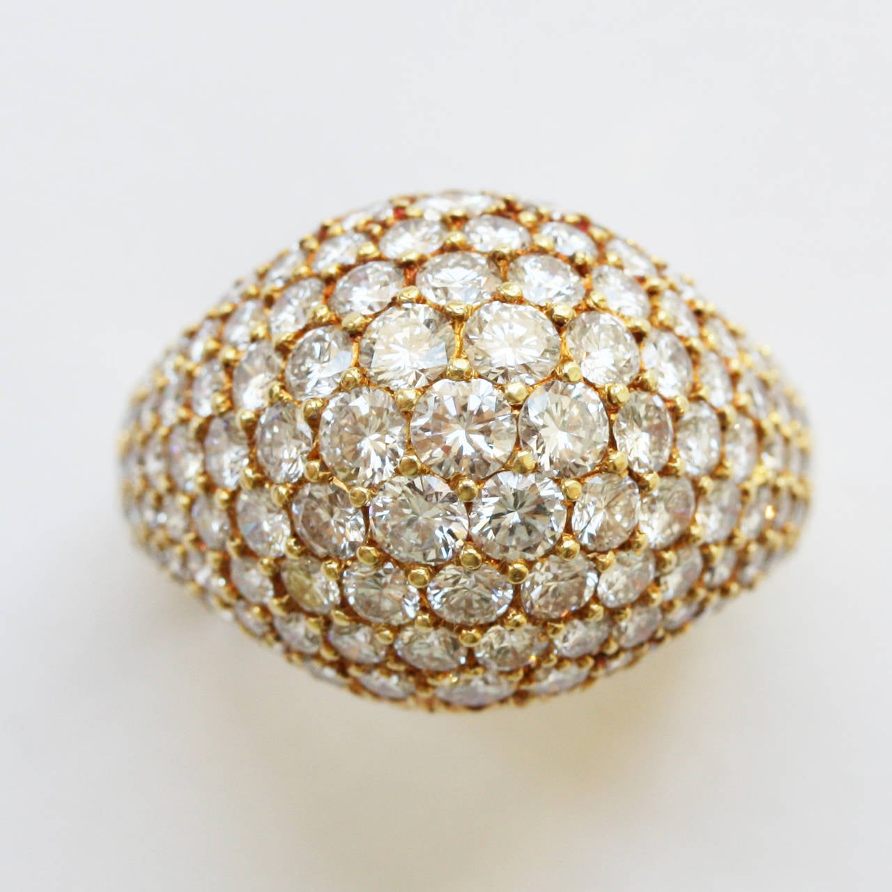 An 18 carat yellow gold bombé ring completely pavé set with brilliant cut diamonds (in total app. 3.5 carats) signed and numbered: Kurt Wayne for Cartier, 45623, 70487 41323, USA.

ring size: 17.25 mm. 6 3/4 US.
weight: 10.2 grams