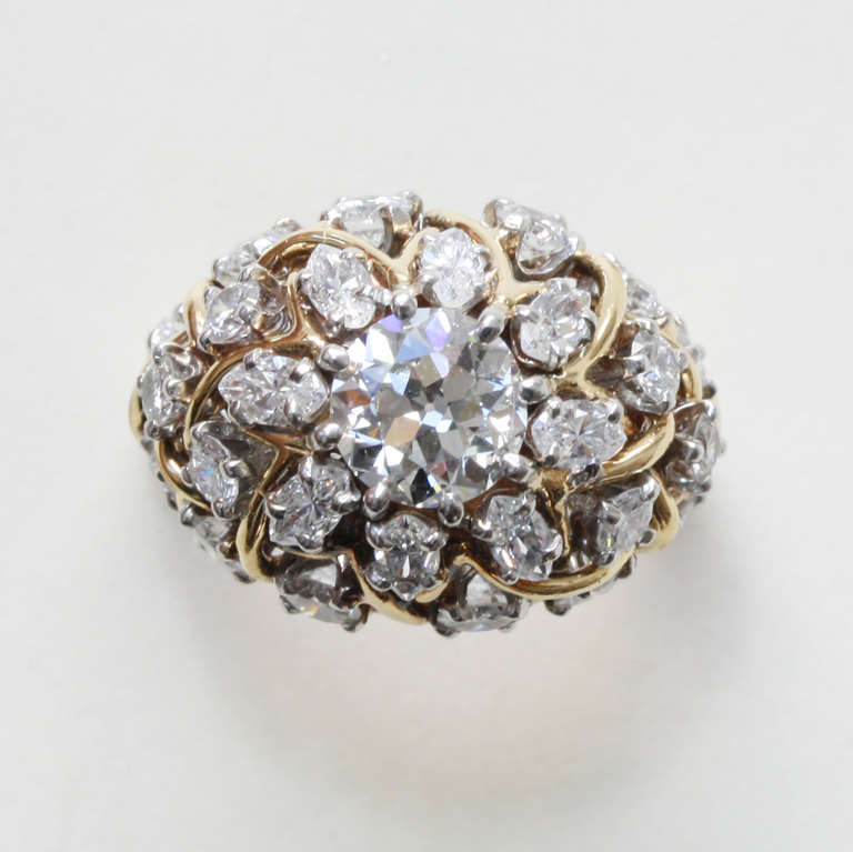 A delicate 14 carat gold cocktail ring with set in platinum navette and brilliant cut diamonds with a brilliant cut center stone (circa 1.1 carat, VS2, H-I, in total circa 3 carat), signed: Schlumberger for Jean Schlumberger and Tiffany for Tiffany