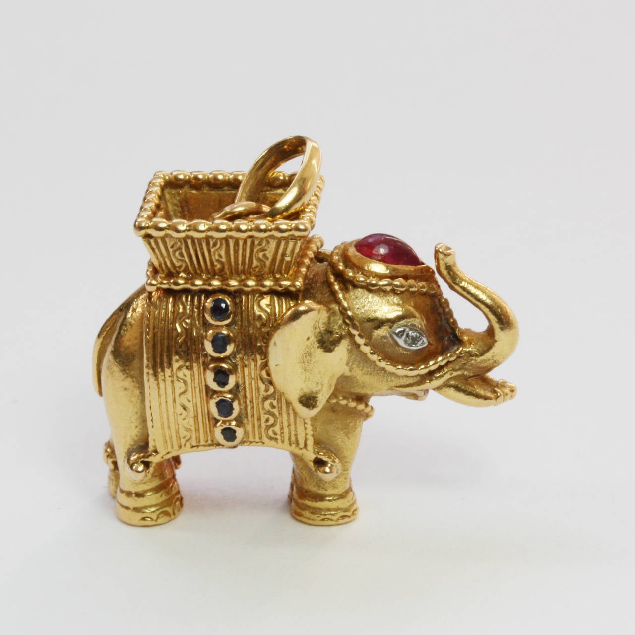 A French 18 carat gold elephant luck charm with a basket on its back that is called a Howdah, or Houdah, which literally means ‘bed carried by a camel’. This kind of seat was used to convey wealthy individuals parading or hunting, in wartime or