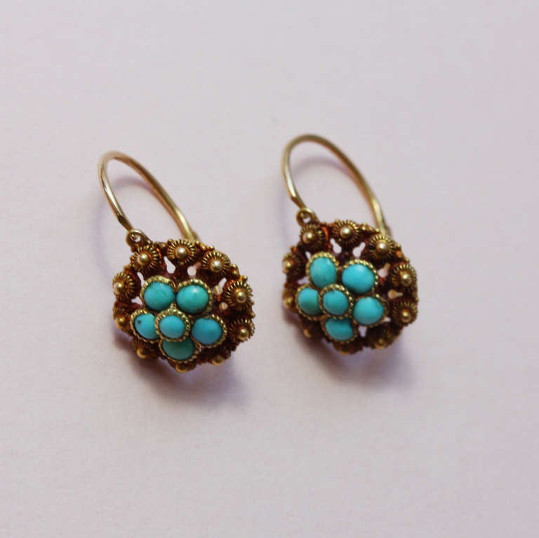 A pair of 18 carat gold earrings decorated with gold 