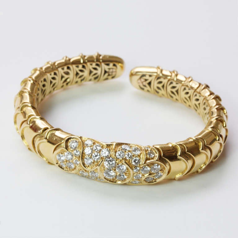 An 18 carat gold and diamond ONDA bracelet, signed: Marina B, French marks, circa 1990.

Weight: 59 grams