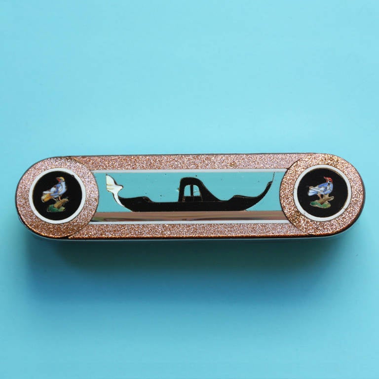 Venetian gondola brooch with micor mosaic and inlayed glass and a silver mounting by Domenico Bussolin, Murano, 19th century.

Weight: 21.1 grams
Dimensions: 7.2 x 1.7 cm.